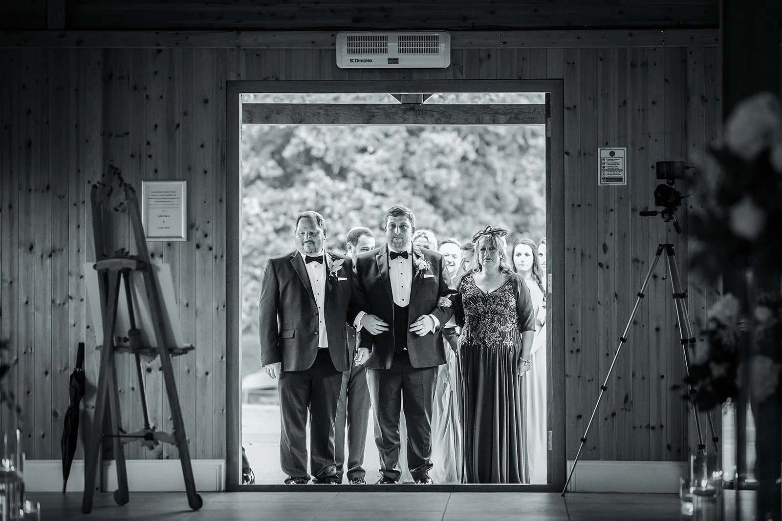 Merrydale Manor wedding bride escorted down aisle black and white – wedding photography North West