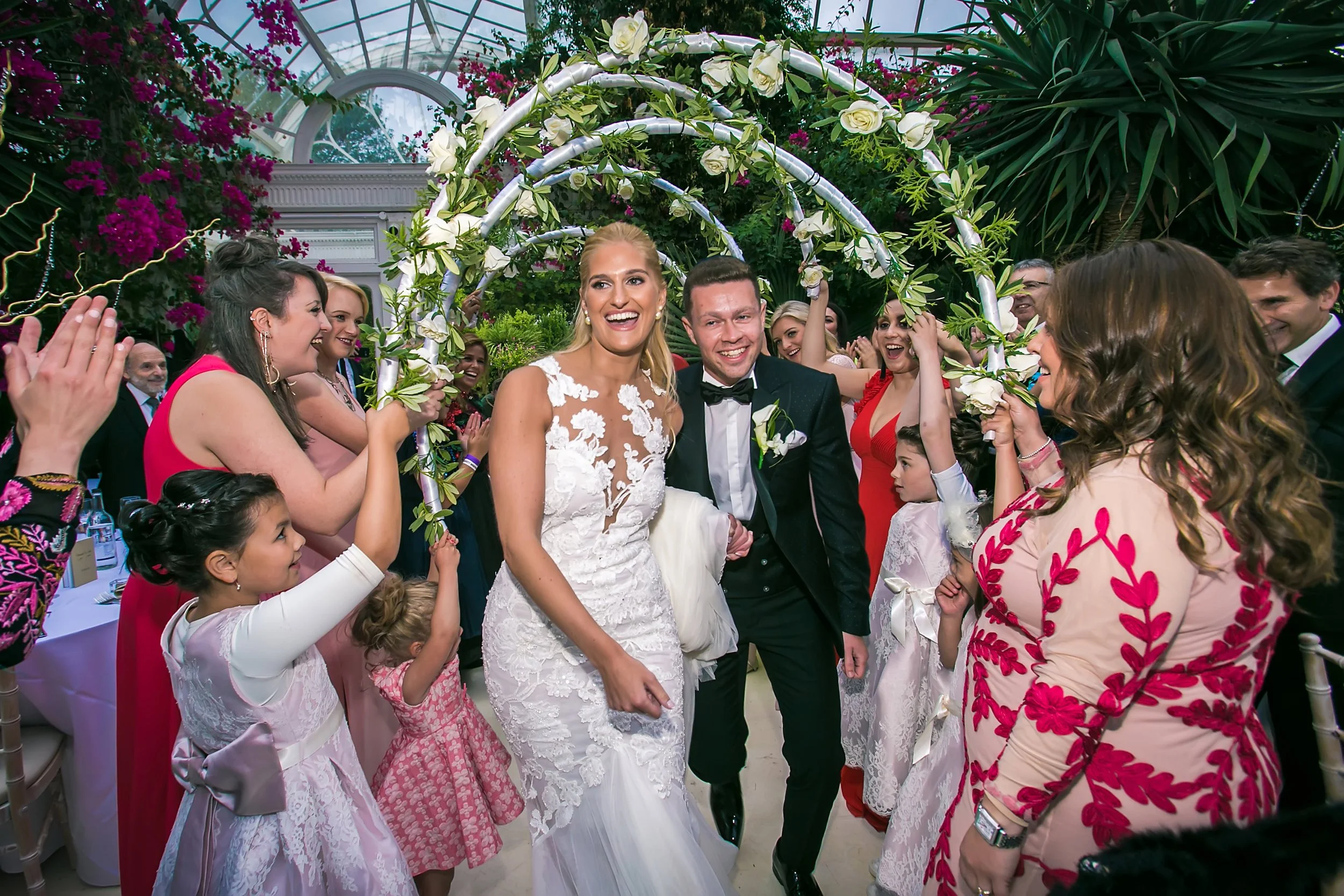 bride and groom make entrance onto dance floor wedding reception at sefton park palm house in liverpool