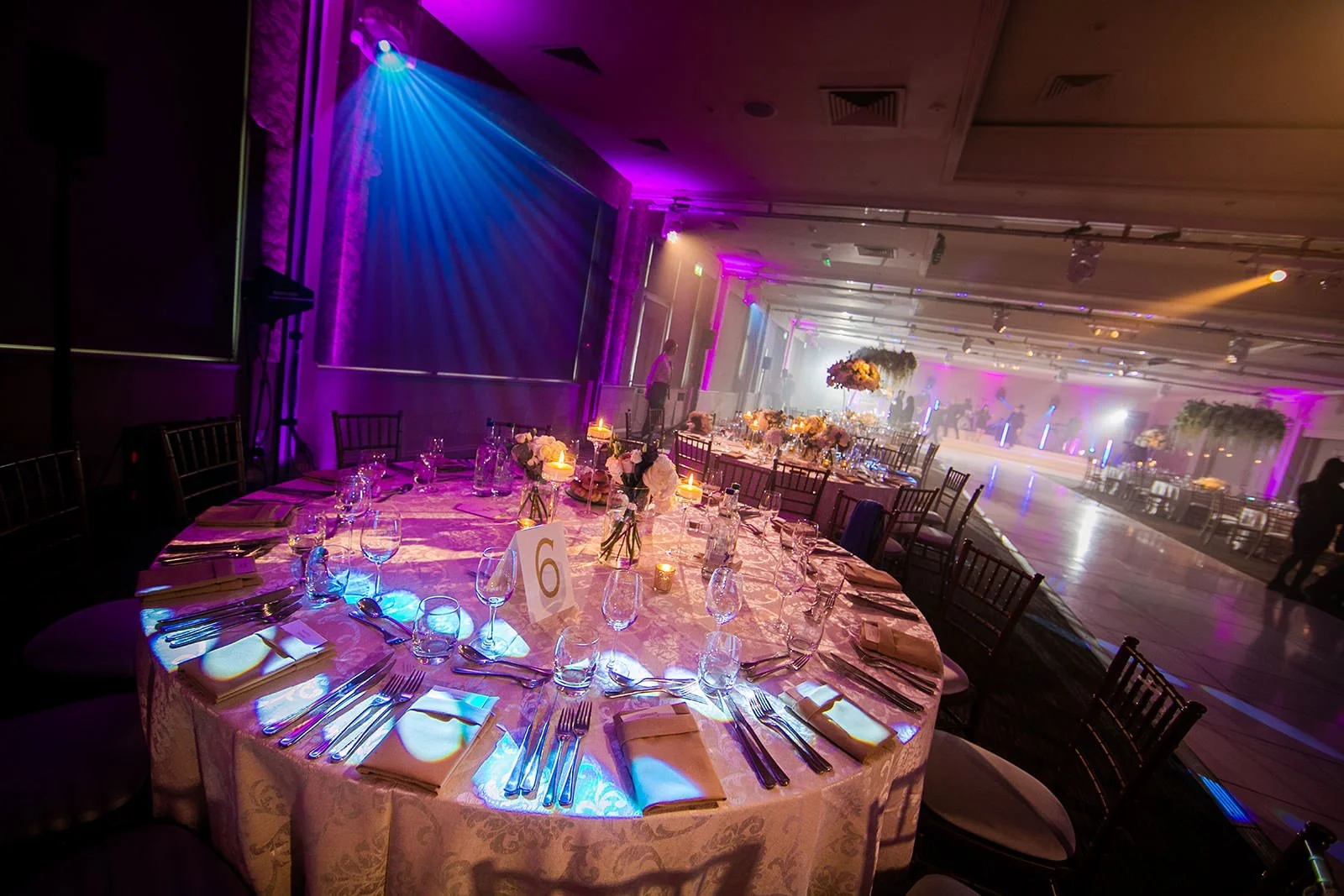 Elegant round table with gold cloth and blue lighting, Fairmont Cheshire The Mere
