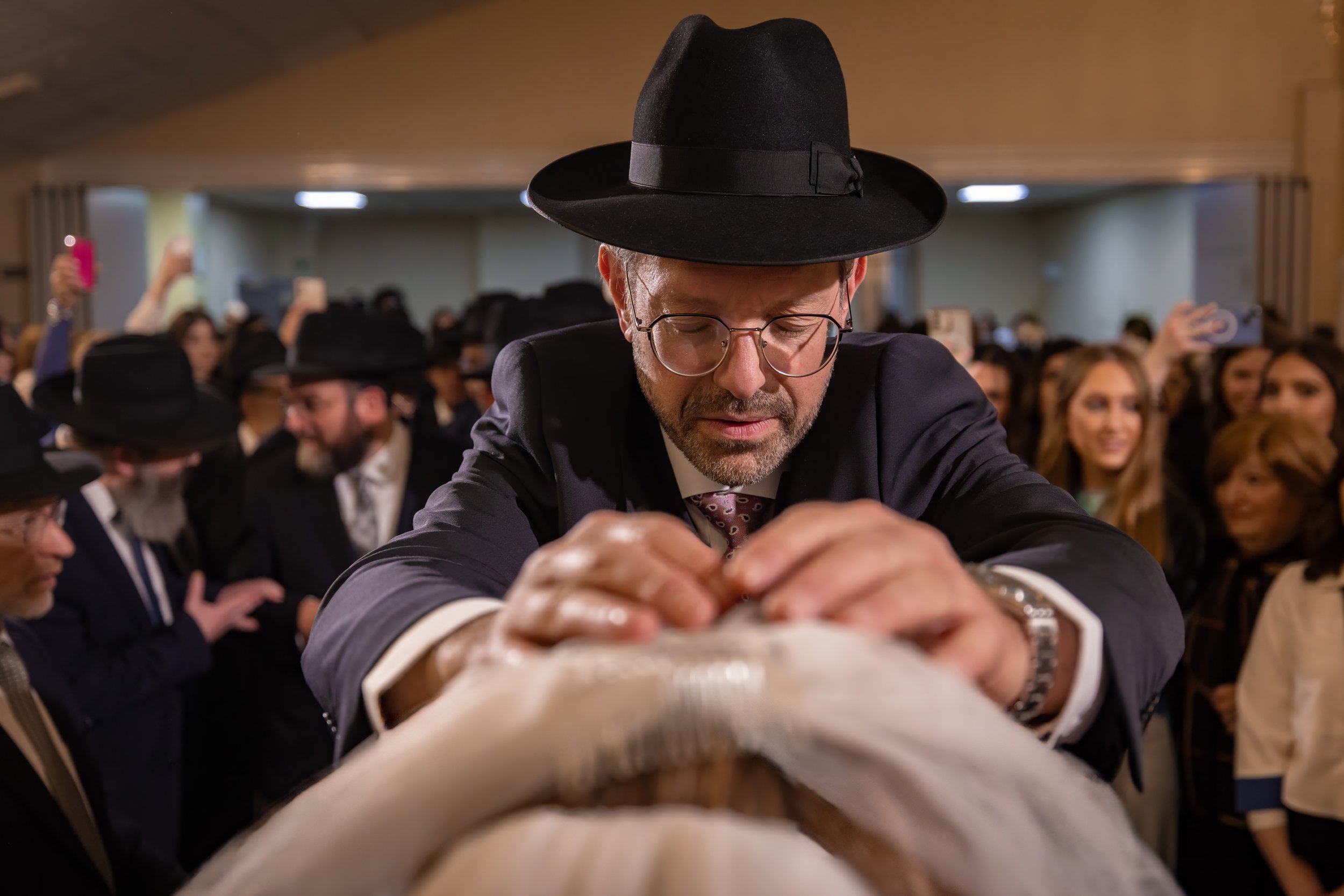 kallah bride receives blessing from father during bedeken at charedi jewish wedding