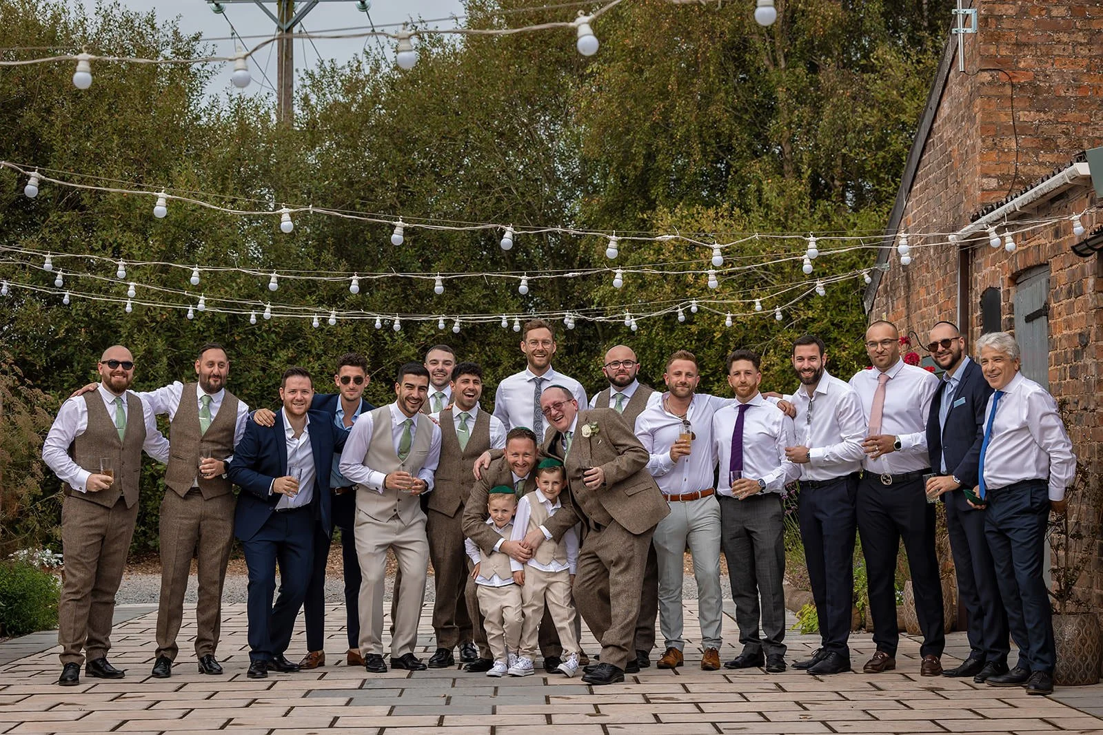 Groom and groomsmen portrait in courtyard at white syke fields wedding venue