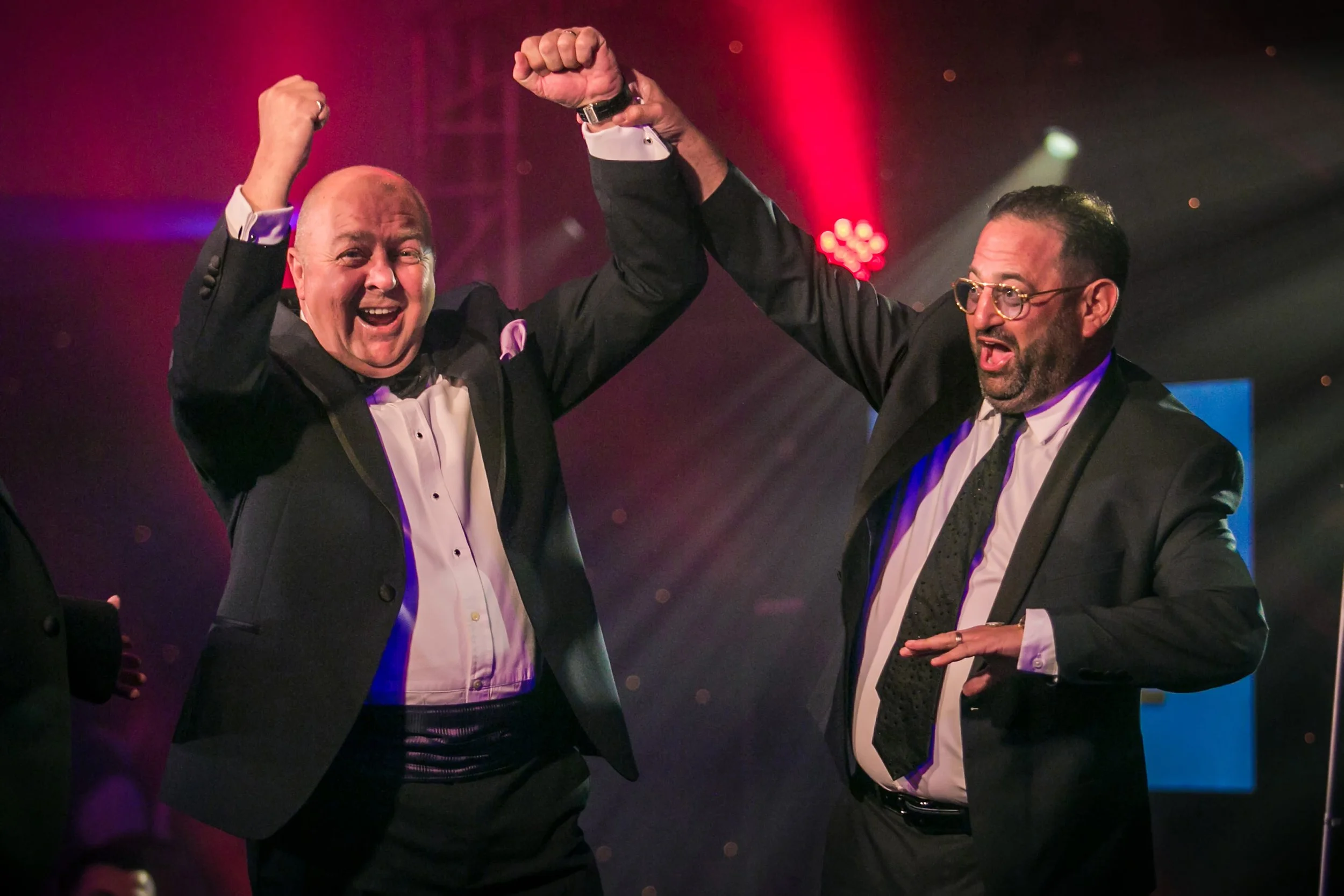Award winner celebrating on stage during a business awards event