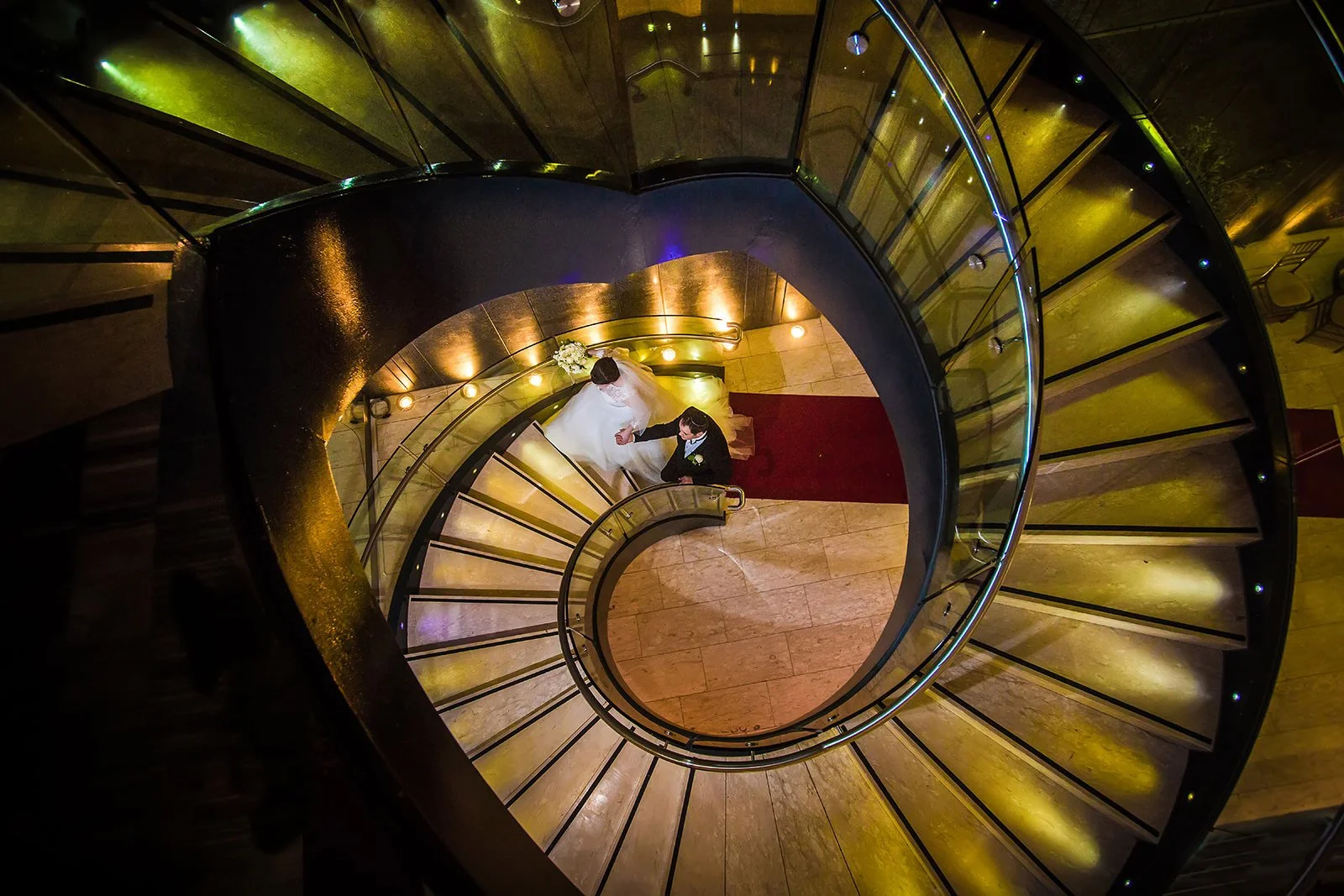 Jewish bride and groom newlywed couple portraits on spiral staircase photographed by a Manchester wedding photographer 