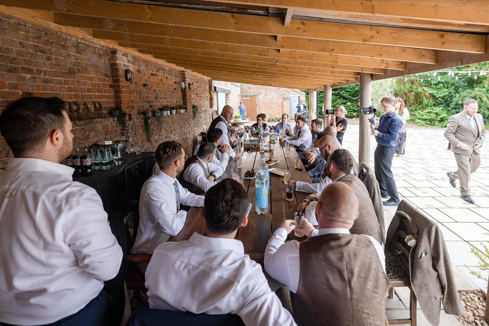 groom and groomsmen enjoy a drink in the roost at white syke fields wedding venue in yorkshire