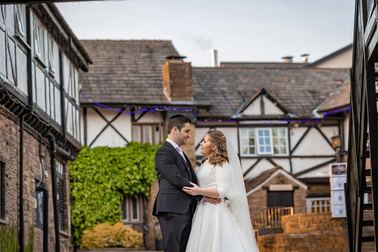 bride and groom newlywed couple portrait in tudor village at last drop village wedding venue in bolton