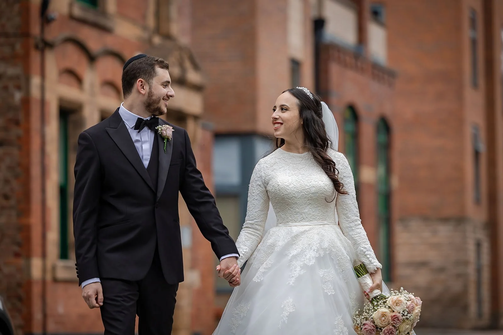 romantic newlywed bride and groom couple portrait outside manchester deansgate hotel