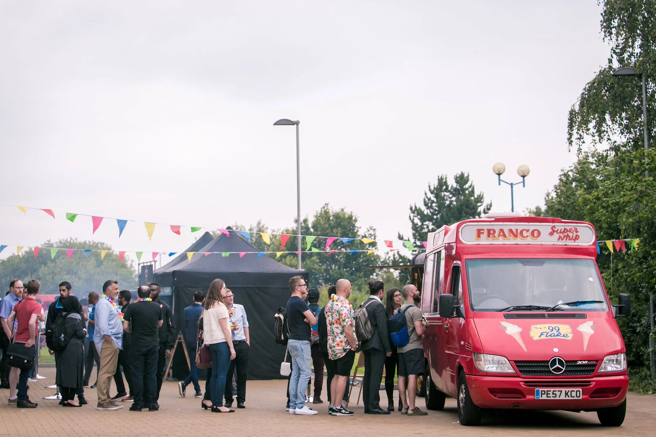 Attendees queuing for an ice-cream outside a business event venue