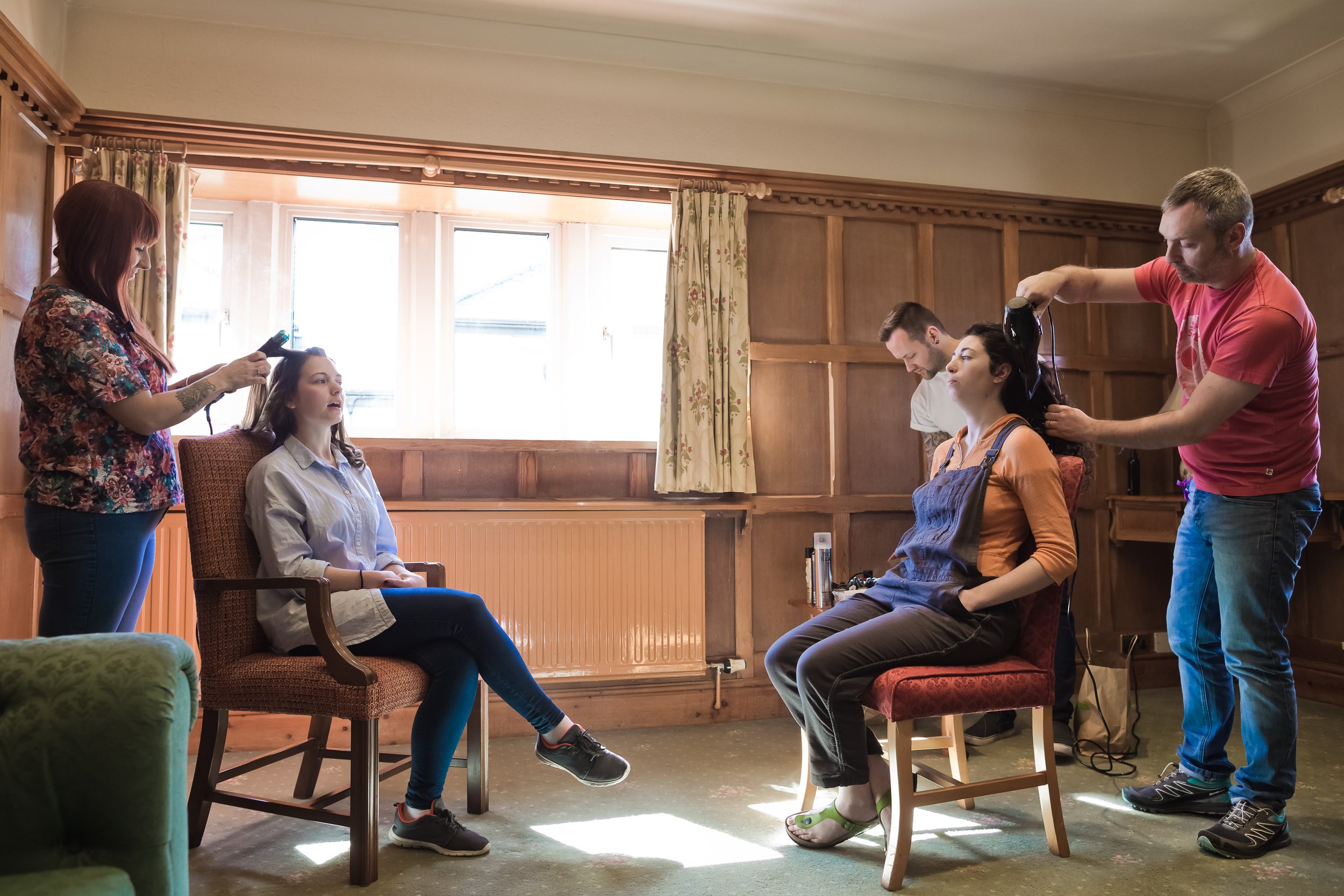 bride having hair done during bridal prep at last drop village in bolton