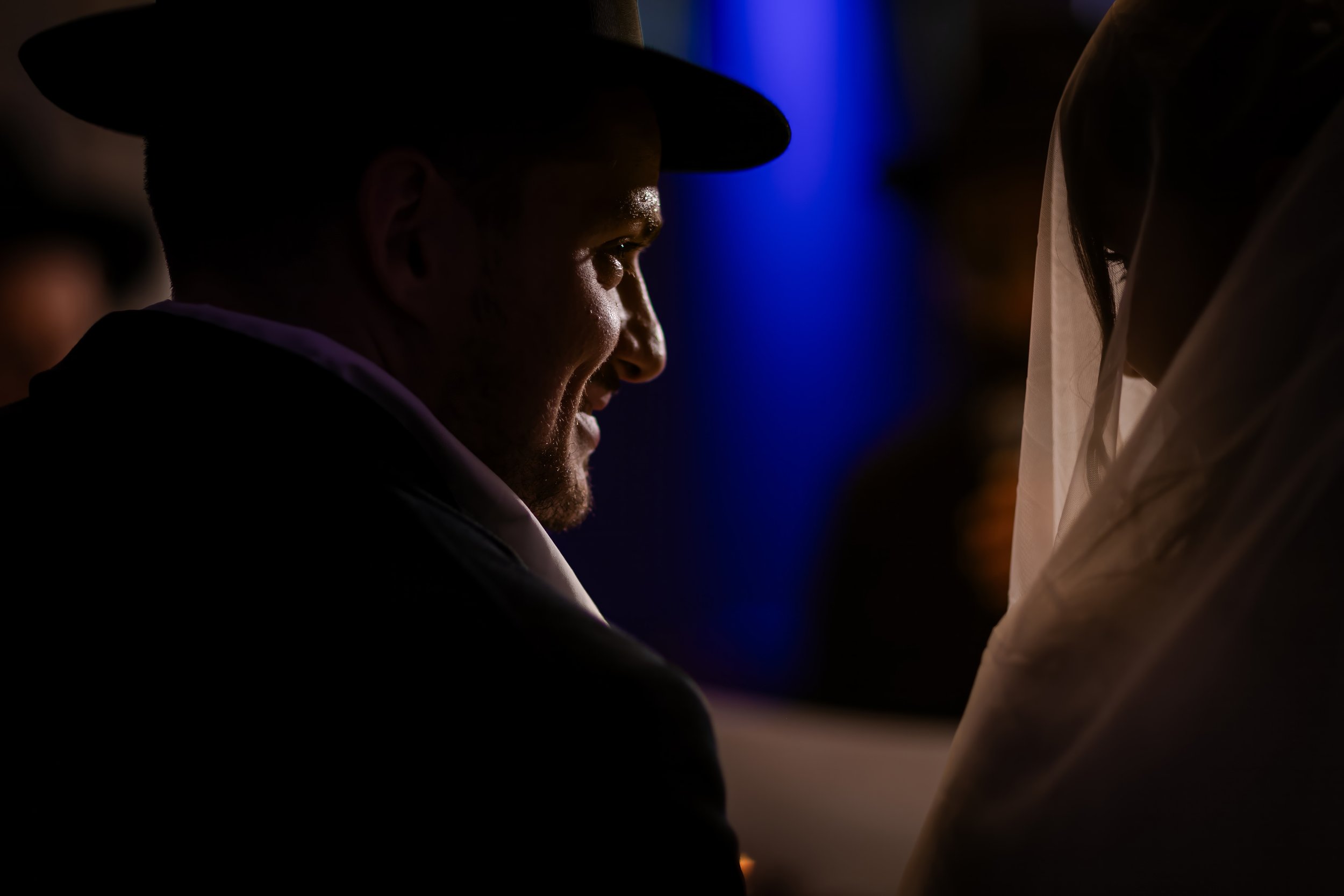 chosson groom looks at kallah bride under chuppah at charedi jewish wedding ceremony