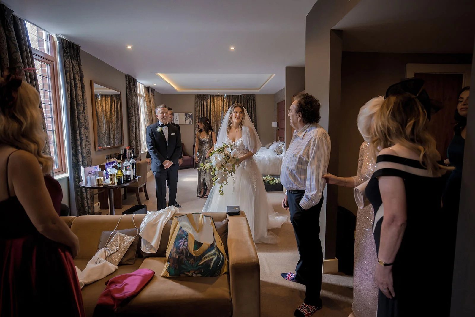 Bride in wedding dress in large hotel suite at Fairmont Cheshire - The Mere


