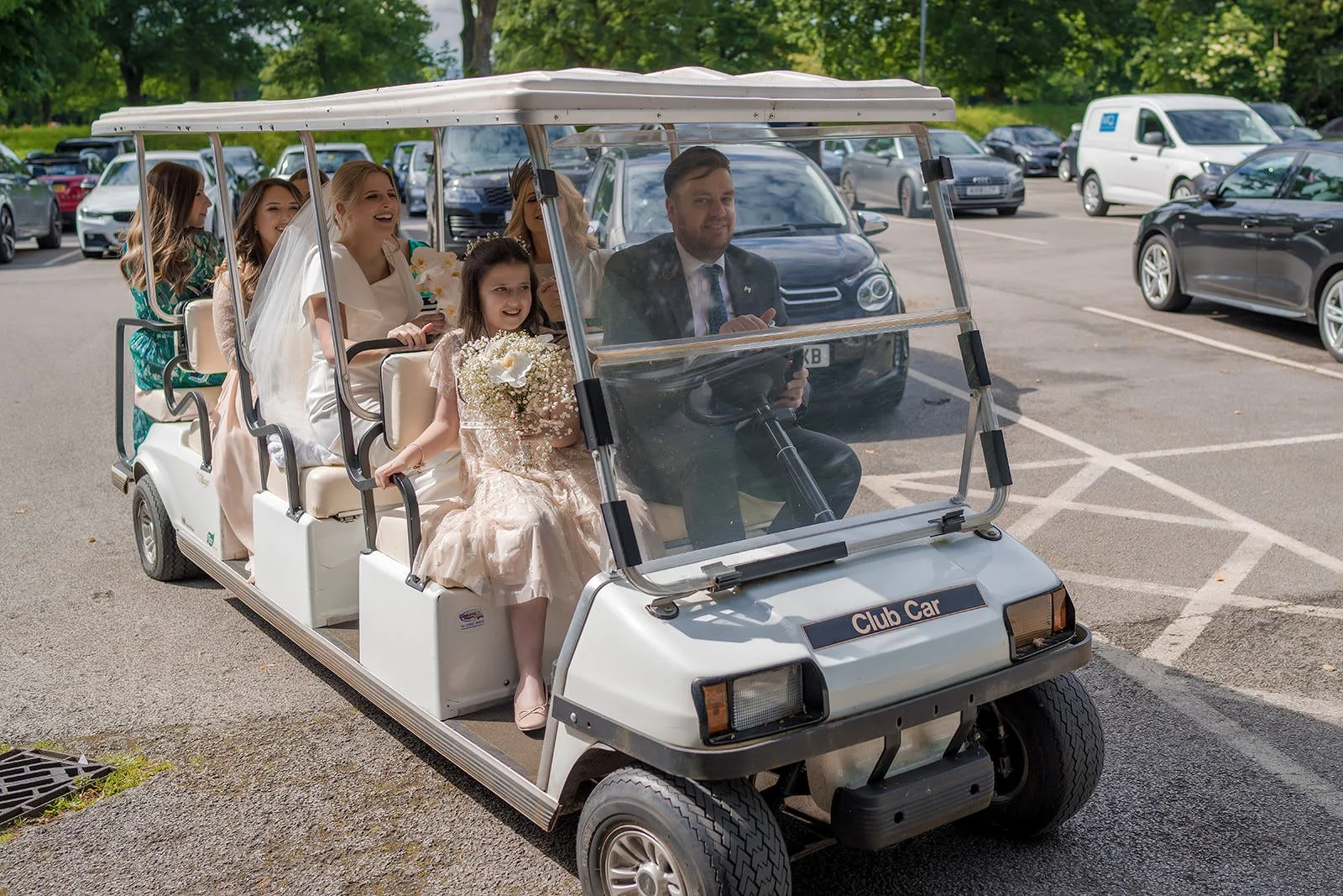 Bride and groom on golf buggy at Fairmont Cheshire - The Mere, Knutsford
