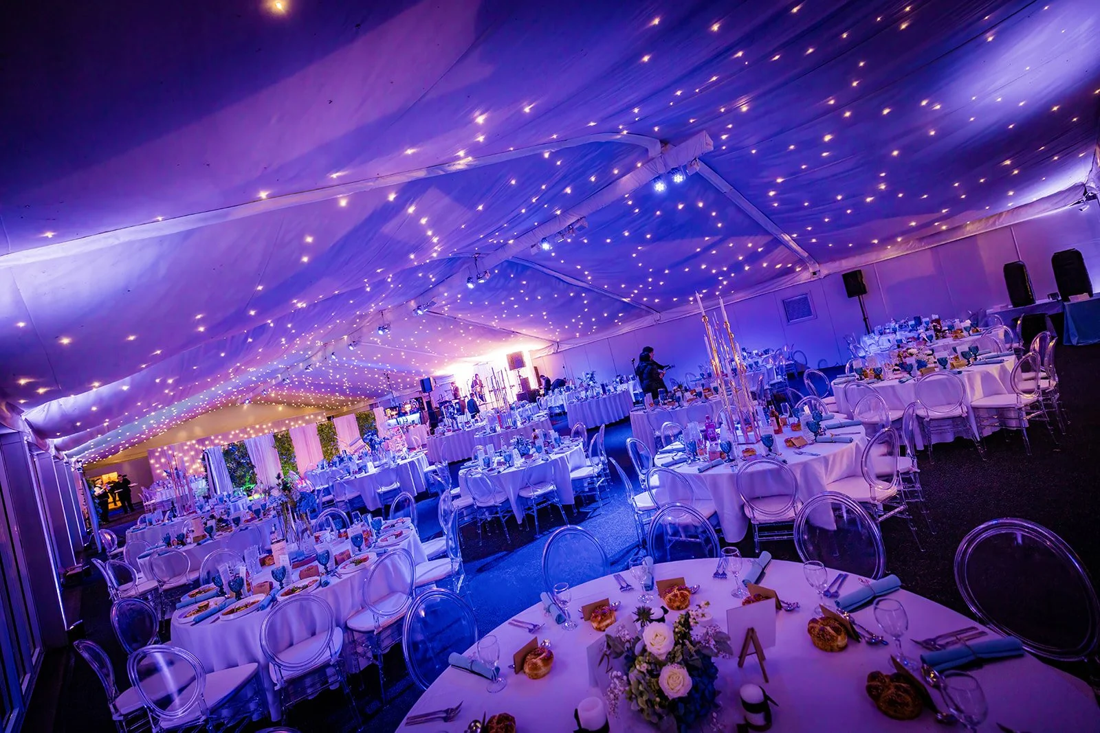 Wide angle of Nunsmere Hall marquee for wedding dinner, starlit ceiling

