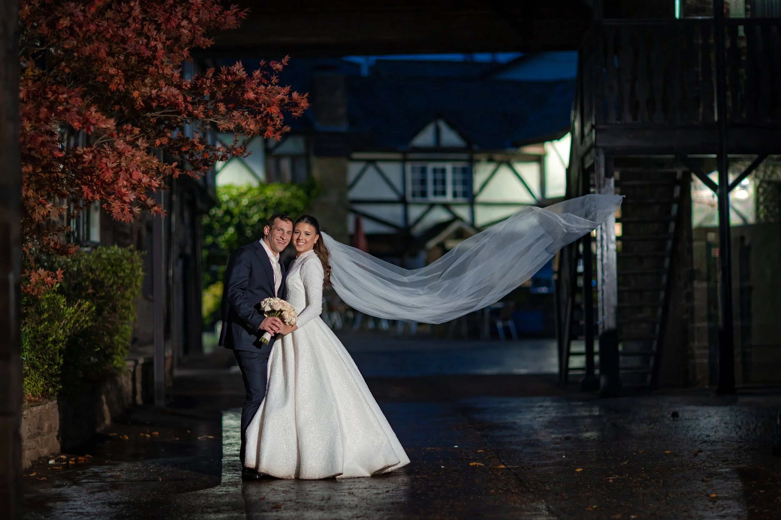 bride and groom newlywed couple portrait with flowing veil at last drop village wedding venue in bolton