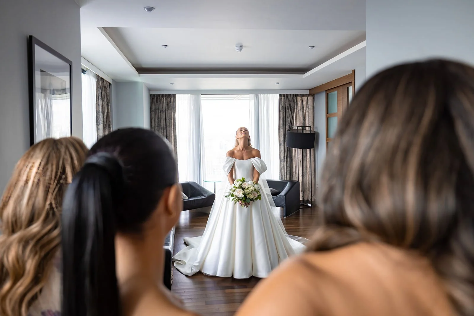 emotional bride first look with bridesmaids during bridal prep at manchester deansgate hotel wedding venue