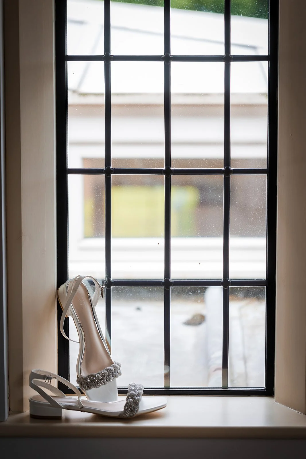 Merrydale Manor wedding bride shoes detail on windowsill – Manchester wedding photographer