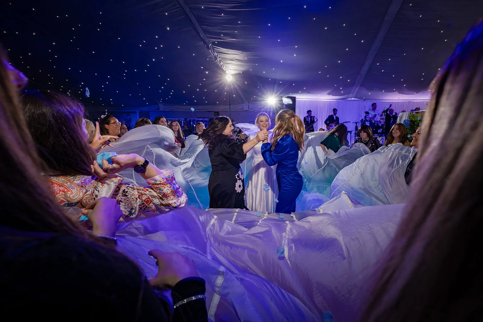 Full dance floor under starlit ceiling in Nunsmere Hall wedding marquee

