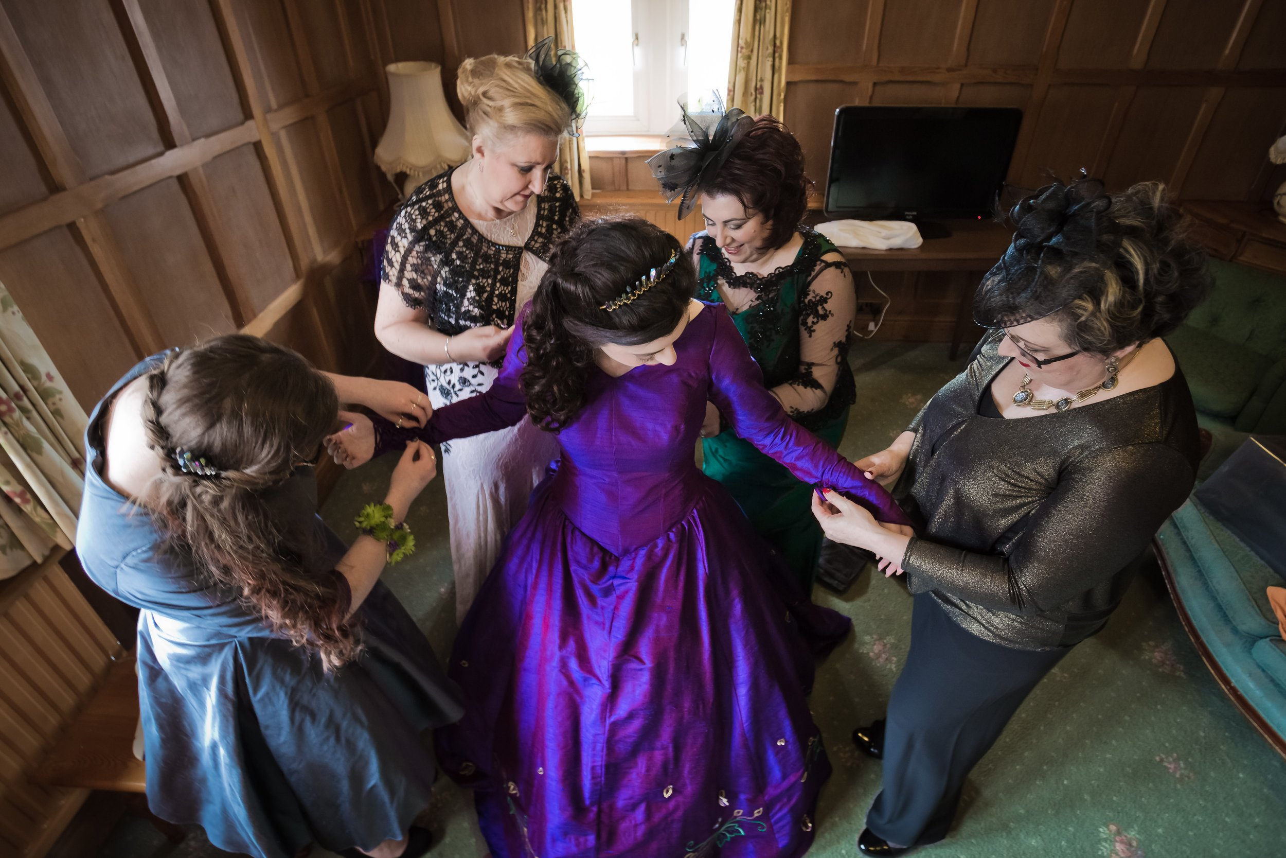 bride getting help during bridal prep at last drop village in bolton