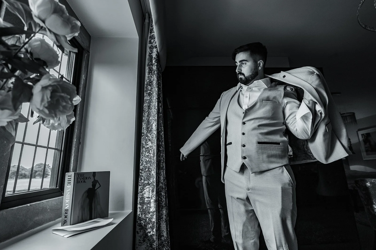 Merrydale Manor wedding groom portrait by window with flowers – fine art wedding photographer North West