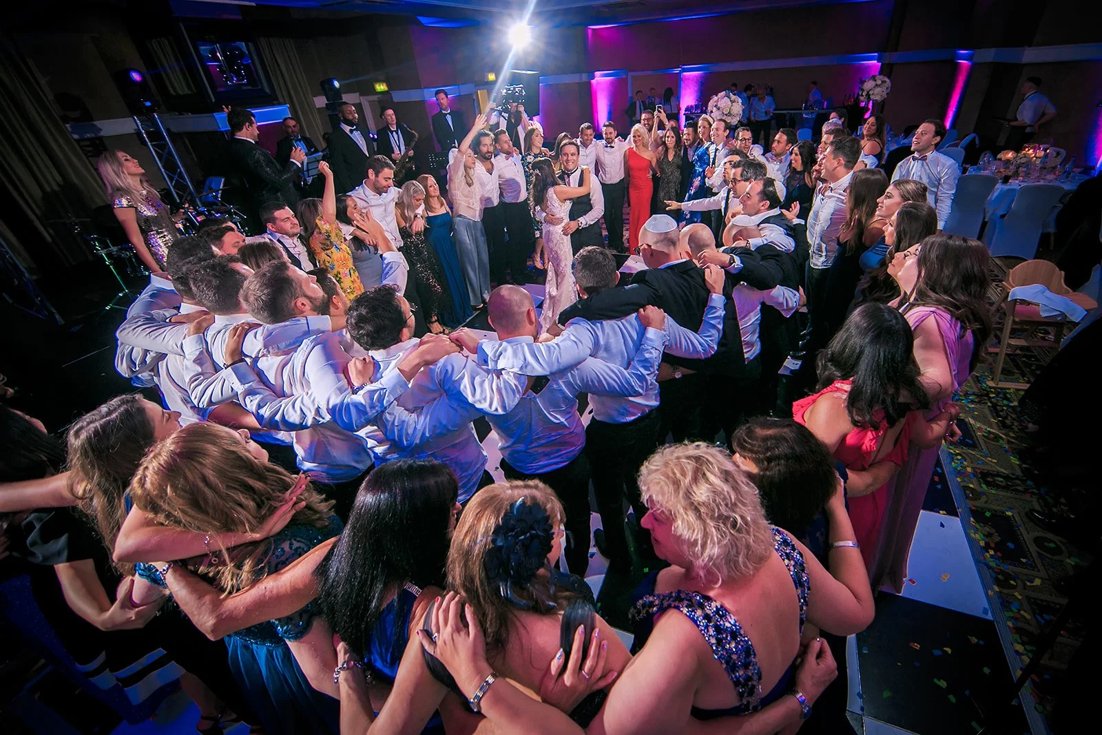 wide angle crowd surrounding bride and groom during wedding reception dance floor at midland hotel