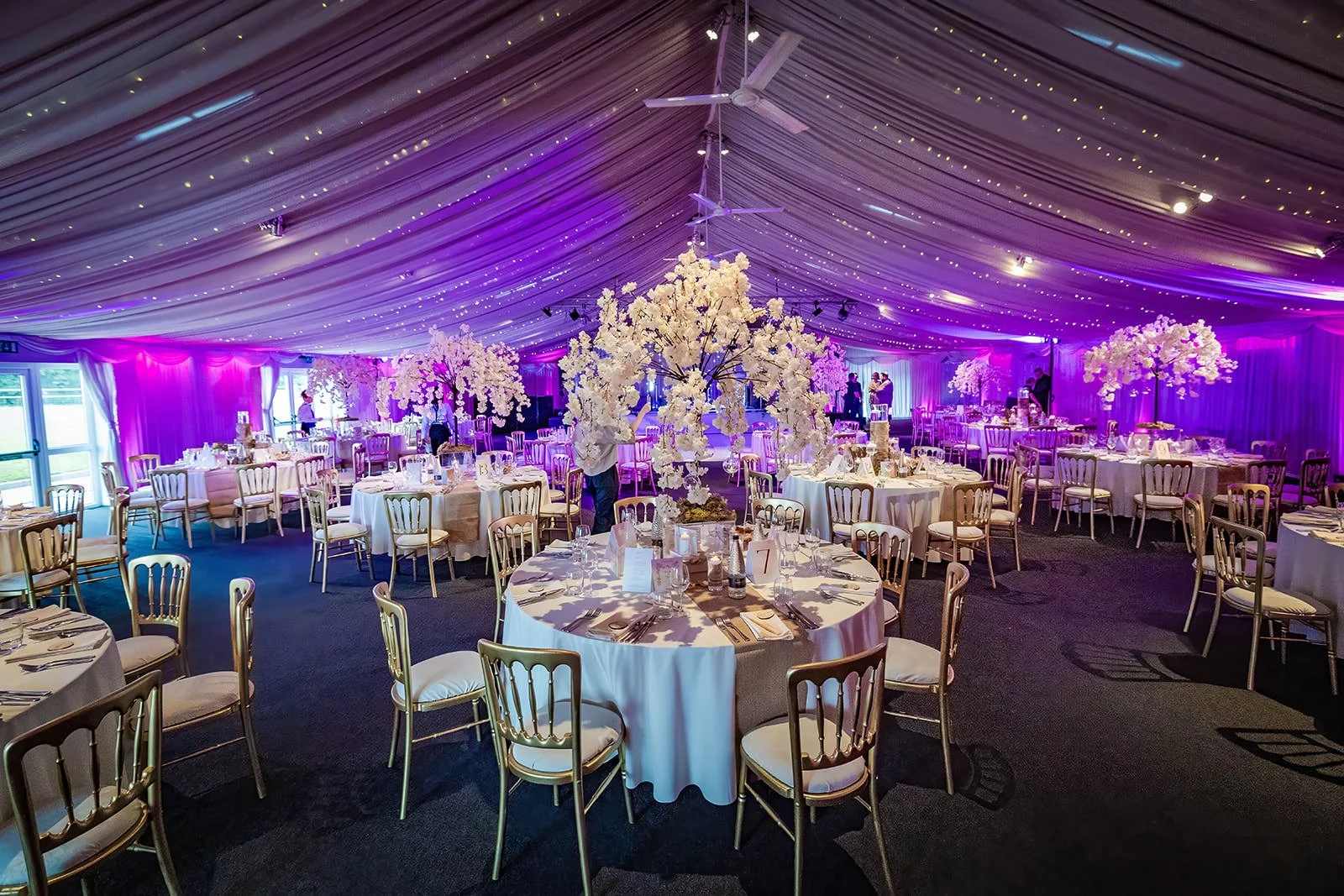 heaton house farm wedding reception dinner set up in steel barns