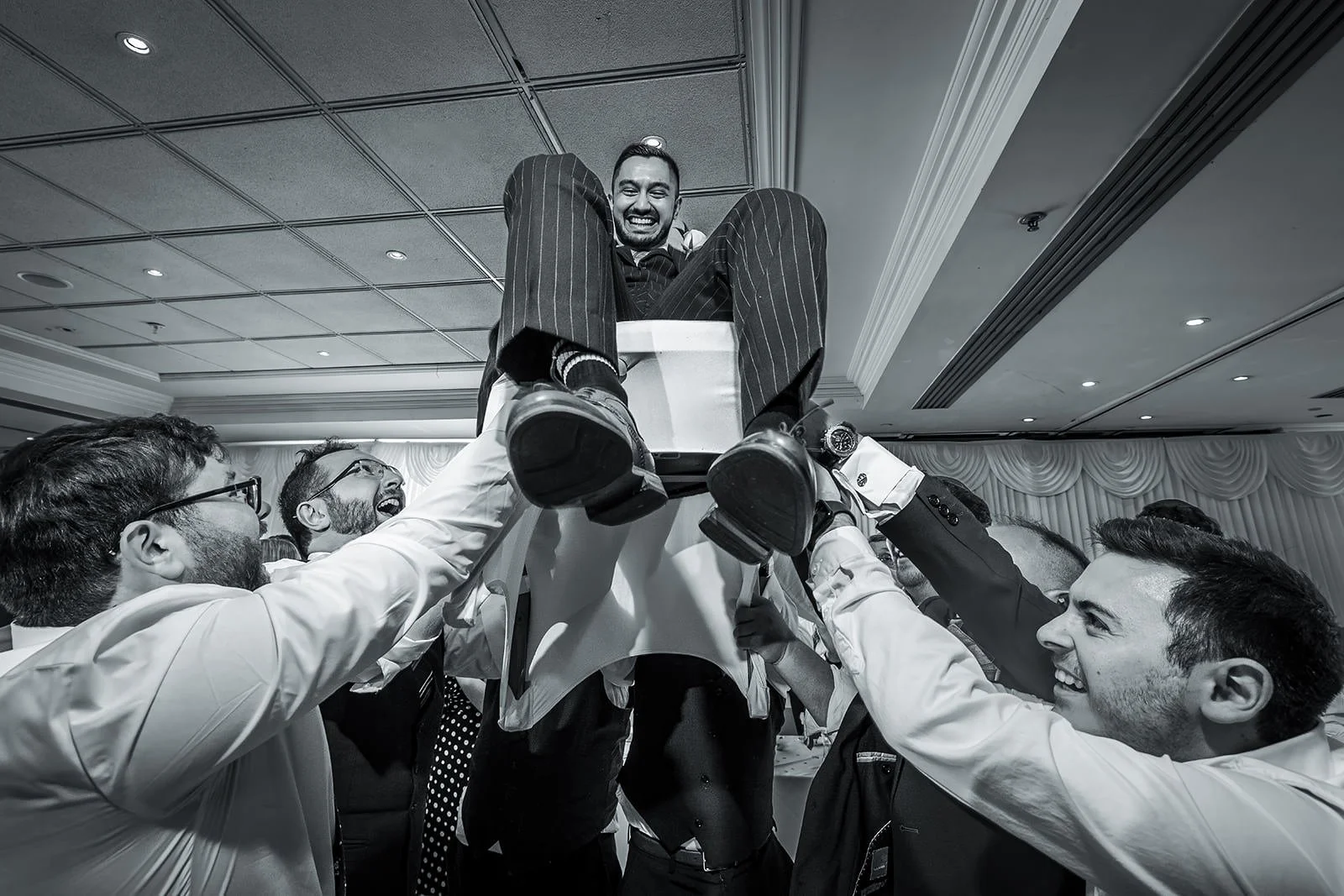 groom lifted on chair during reception party at worsley marriott hotel