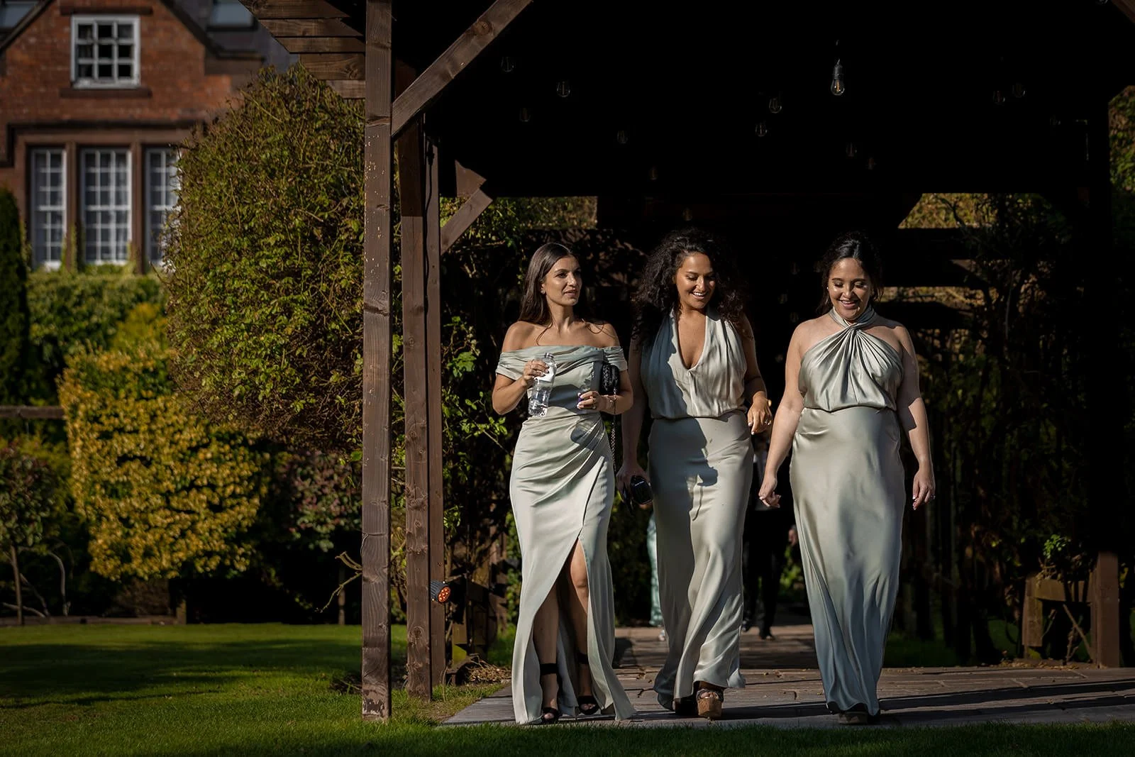 bridesmaids outdoors in italian gardens at nunsmere hall wedding venue in cheshire