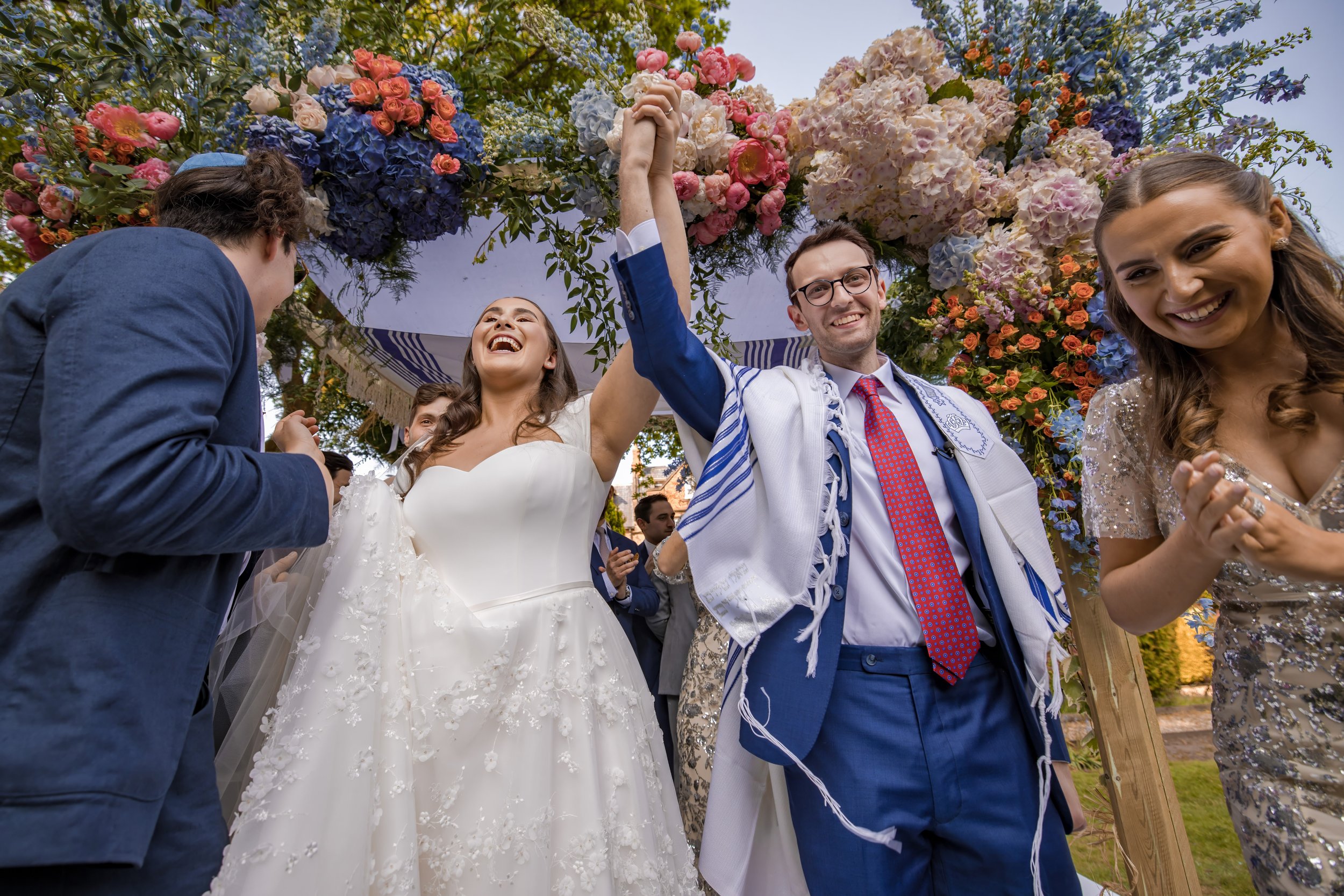 Manchester wedding photography of bride and groom celebrating after leaving chuppah during Jewish ceremony