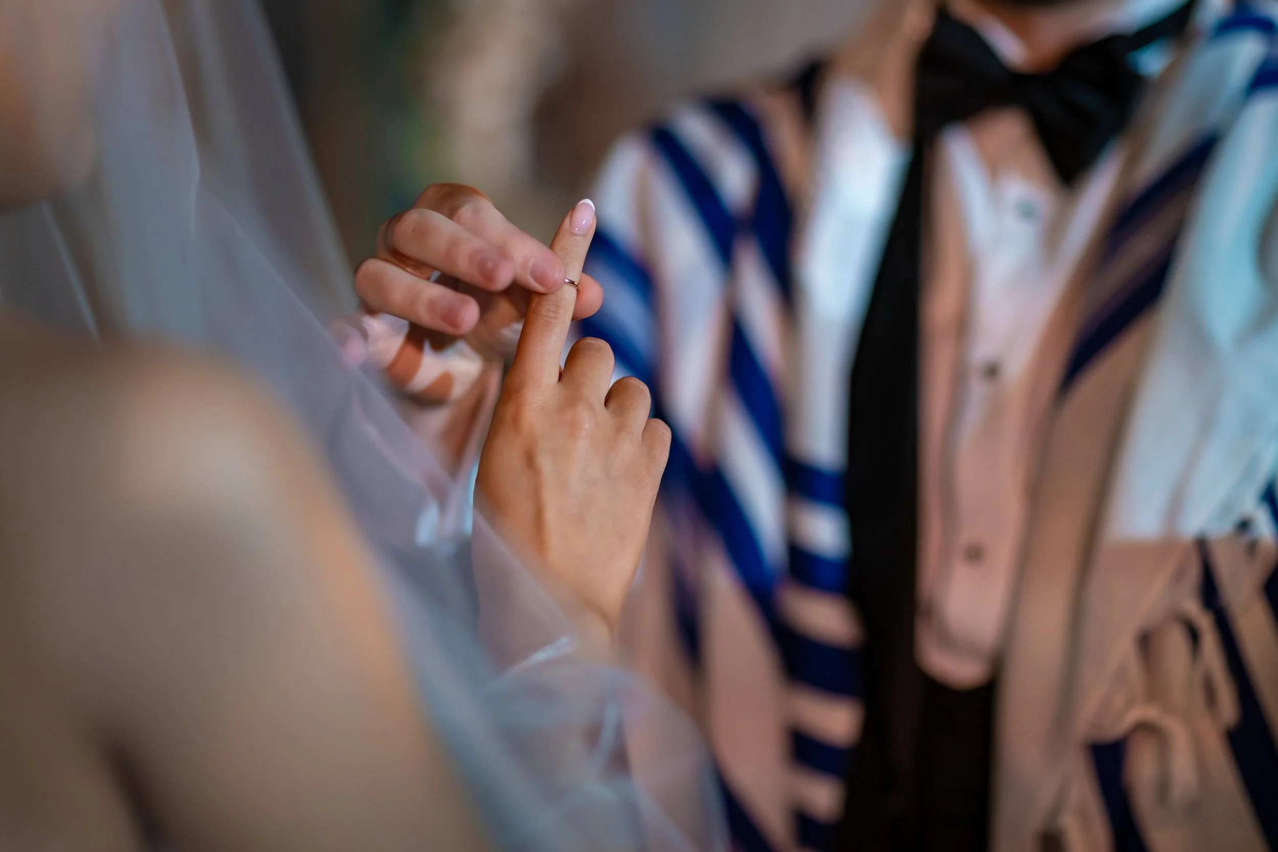 groom puts ring on finger during wedding ceremony at midland hotel