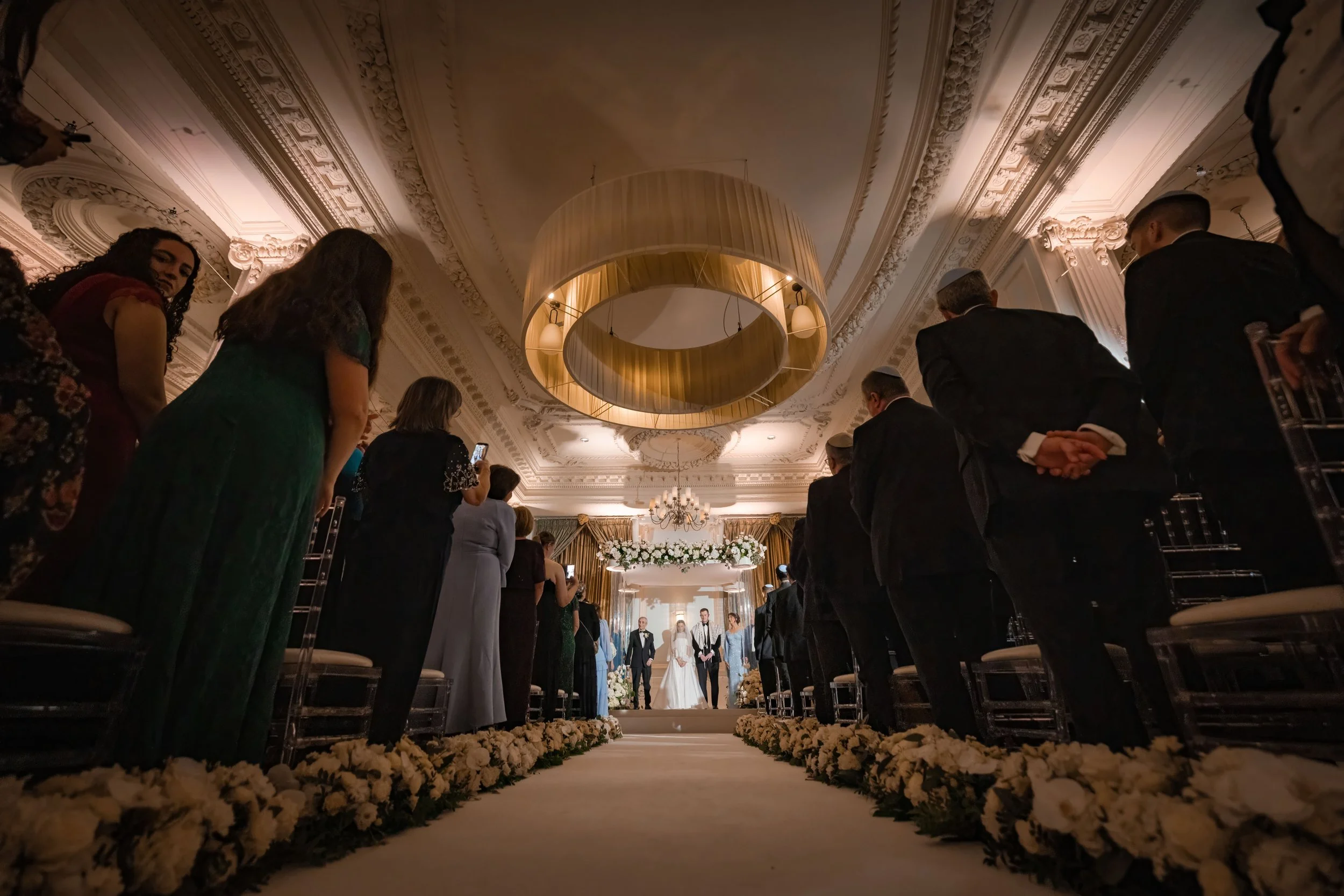 wide angle from back of trafford suite of jewish wedding ceremony at midland hotel in manchester