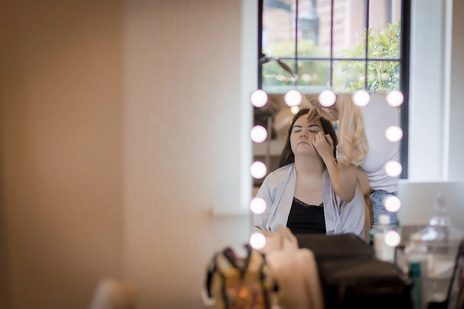 Merrydale Manor wedding bride getting makeup in dressing room – Manchester wedding photographer