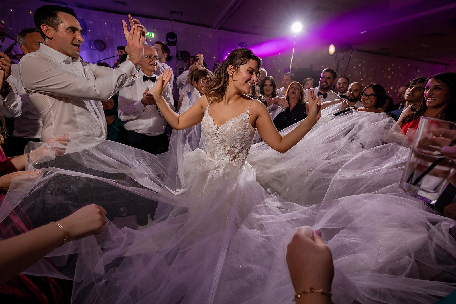 Bride and dress during energetic dancing at Fairmont Cheshire - The Mere
