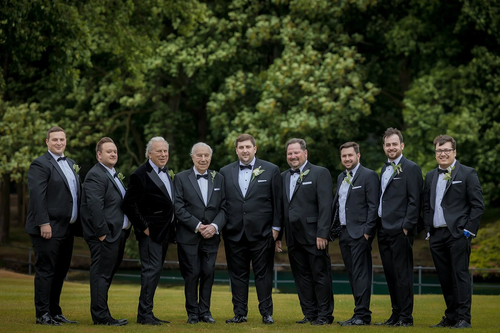 Merrydale Manor wedding groomsmen group portrait in tuxedos outdoors – documentary wedding photography Manchester
