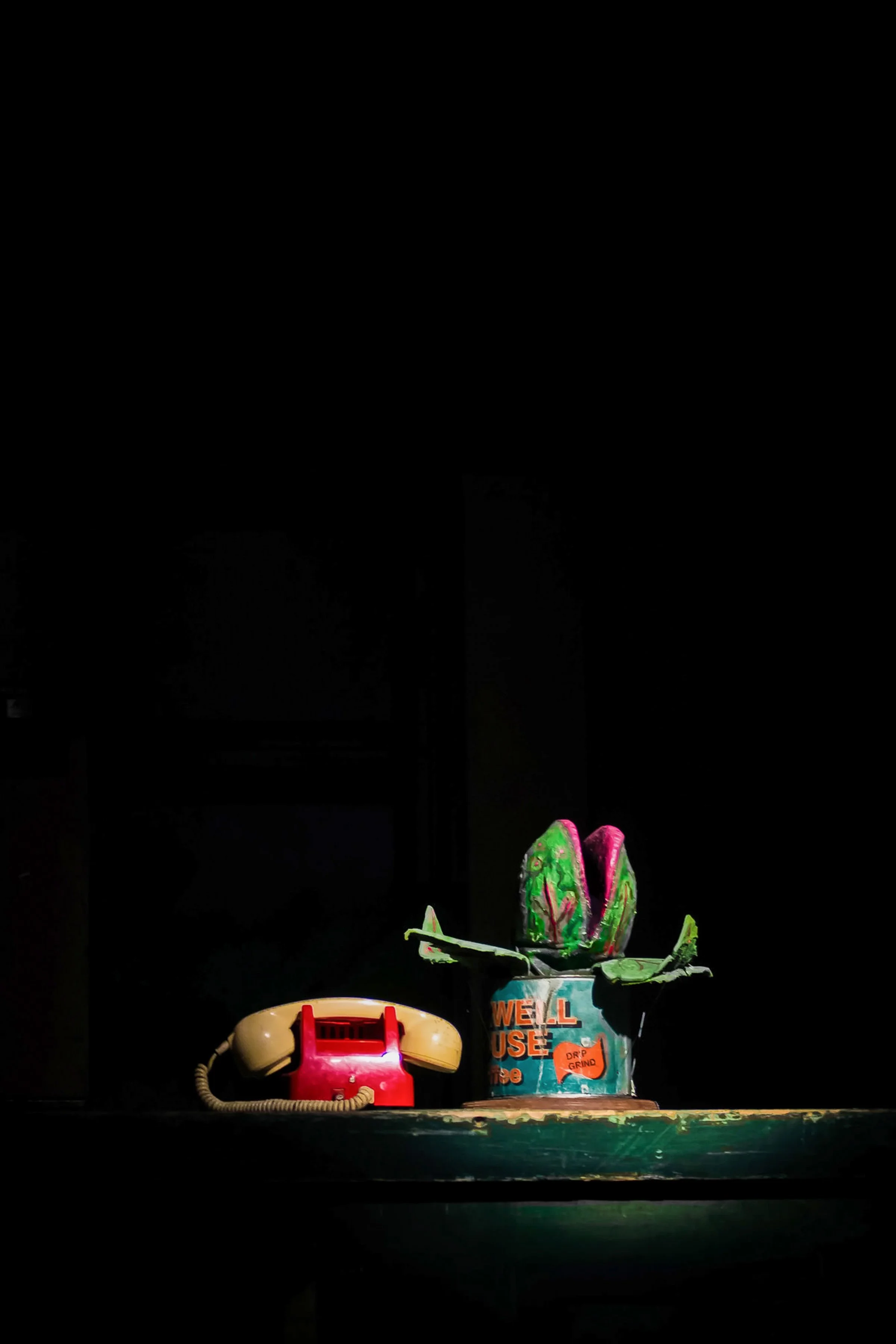 little shop of horrors musical theatre production photograhy with carnivorous plant and phone