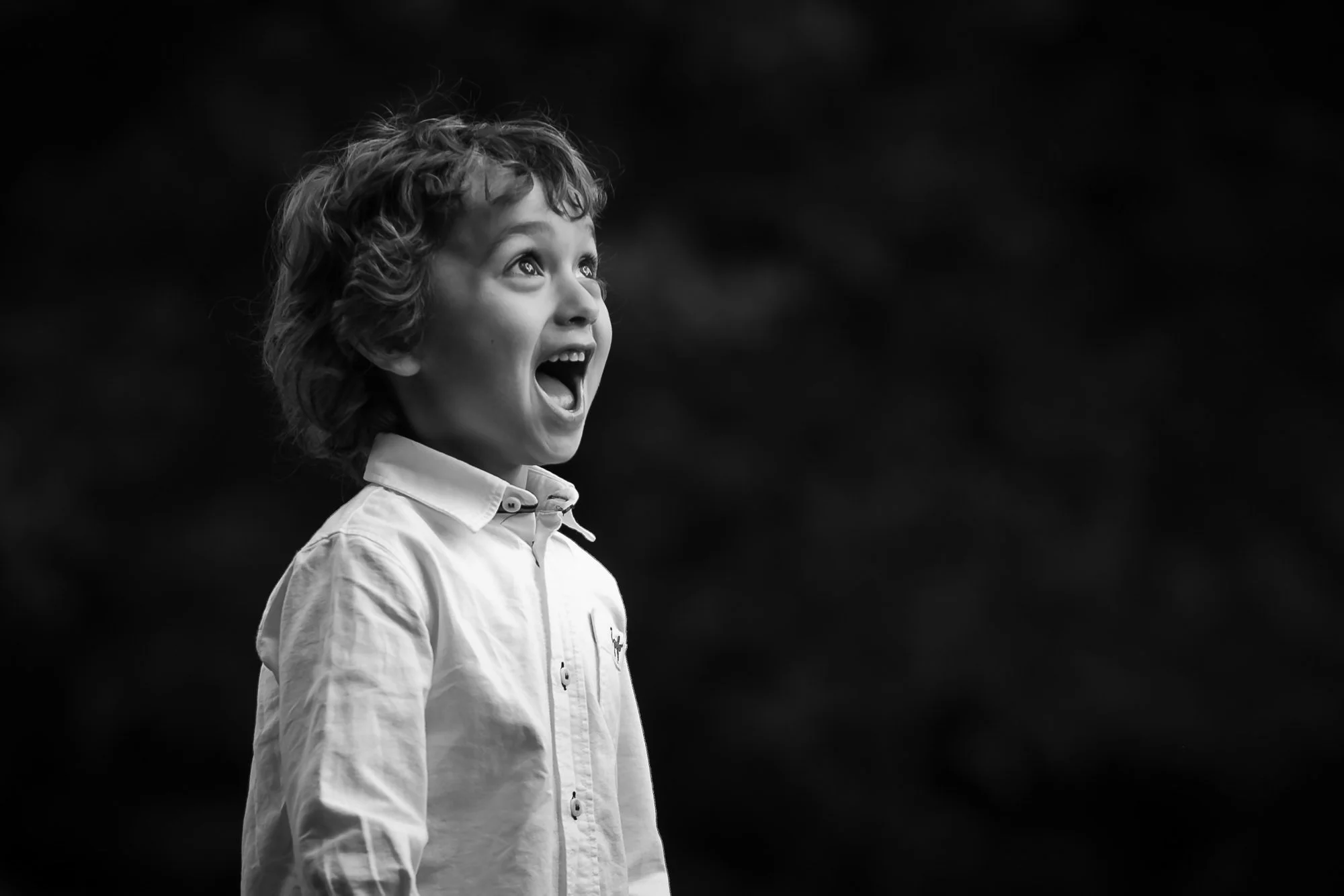 natural light black and white portrait of boy with amazed expression