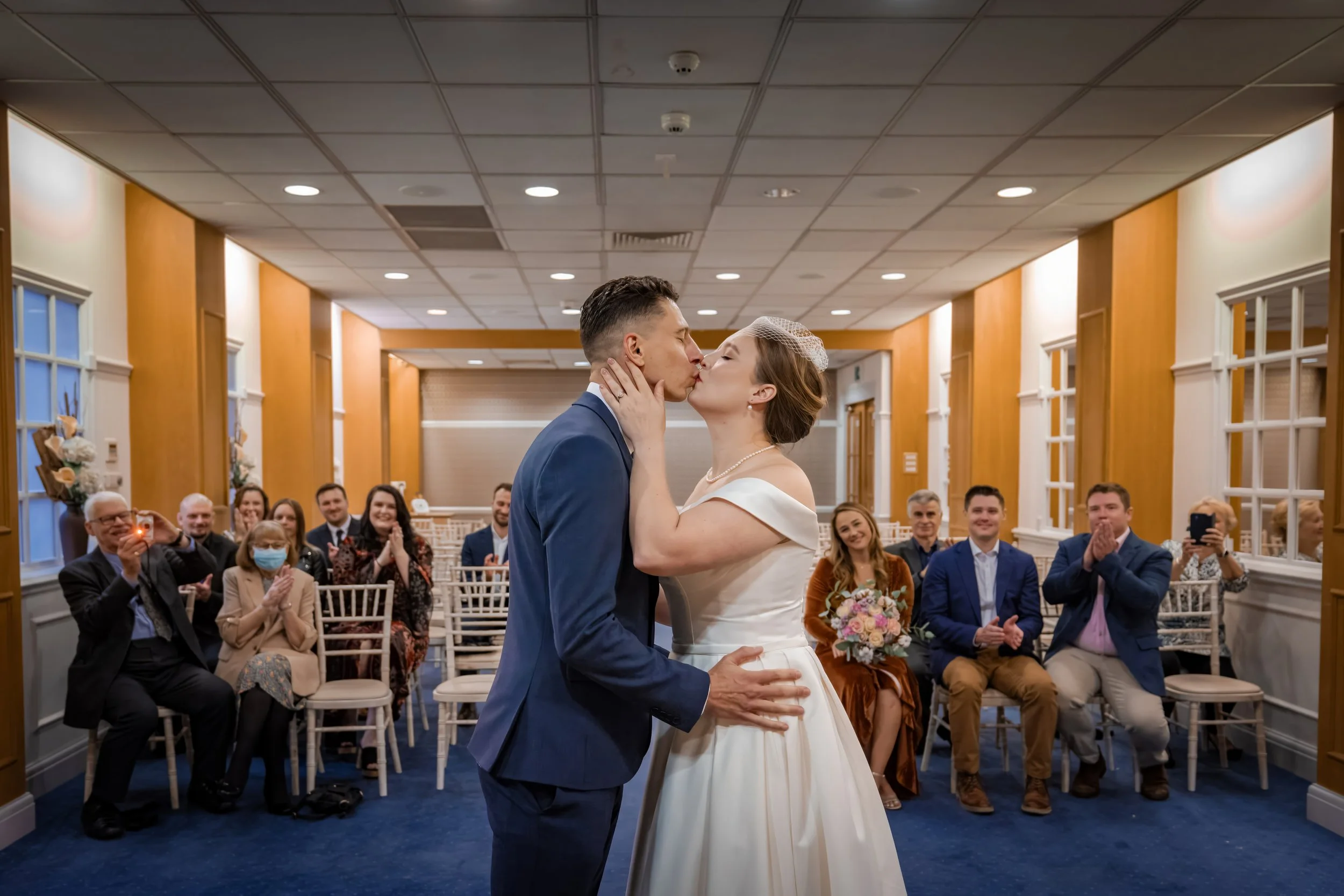 Bride and groom first kiss at end of wedding ceremony