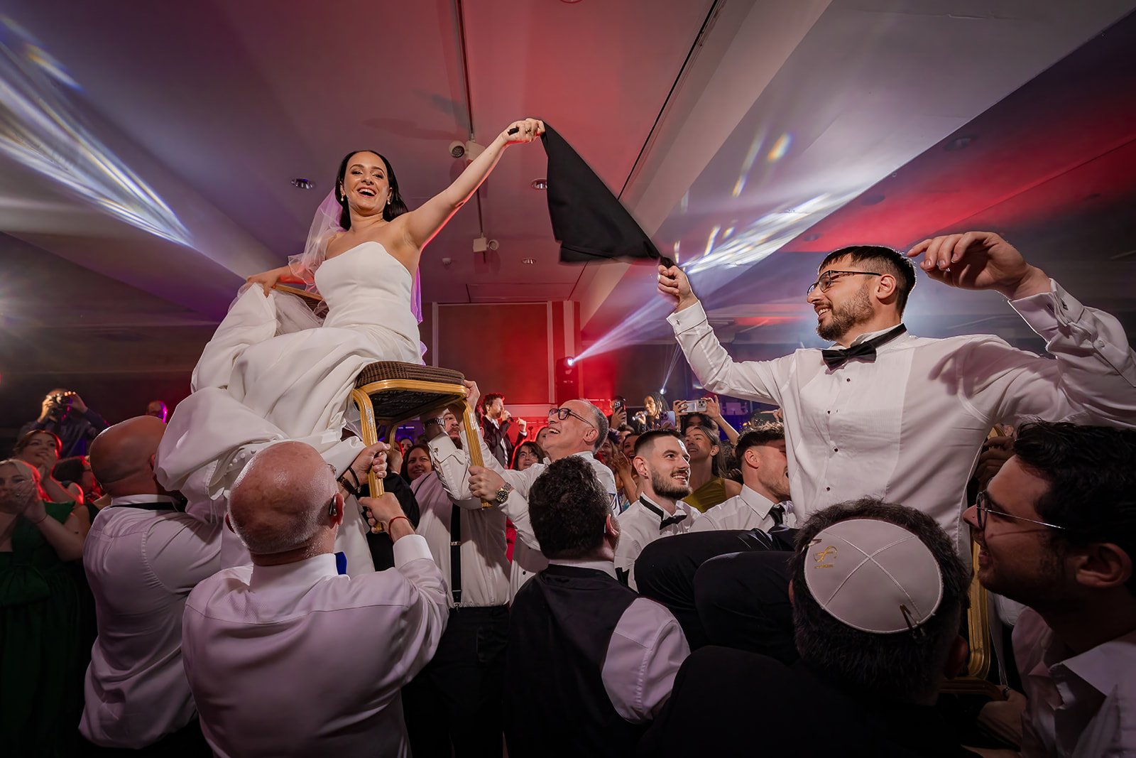 bride and groom lifted on chairs during wedding reception party at Midland hotel