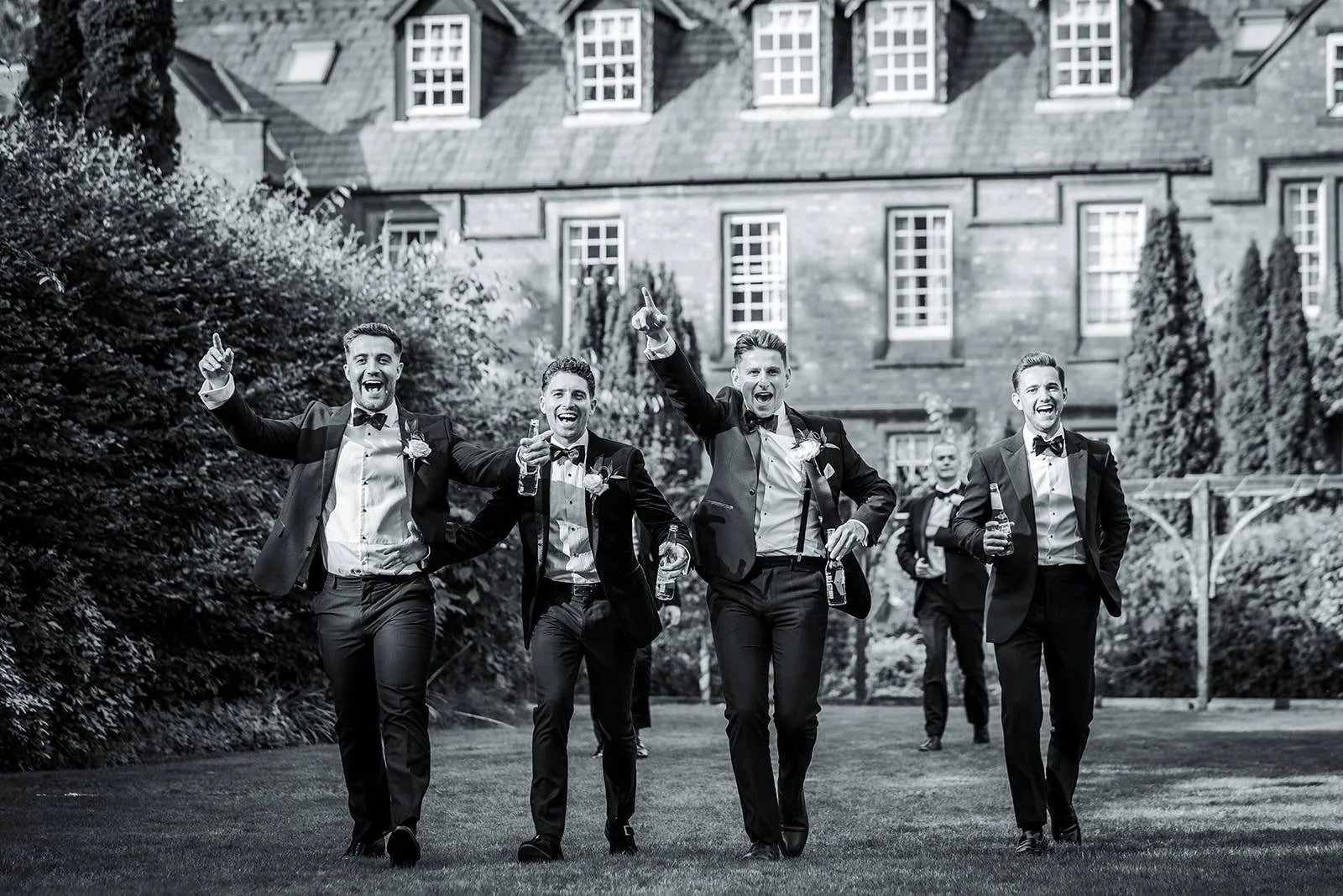 groomsmen in italian gardens at nunsmere hall wedding venue in cheshire