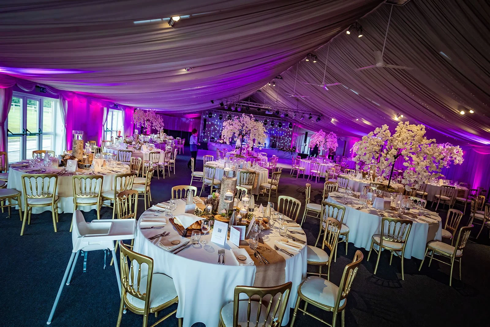 heaton house farm wedding reception dinner set up in steel barns