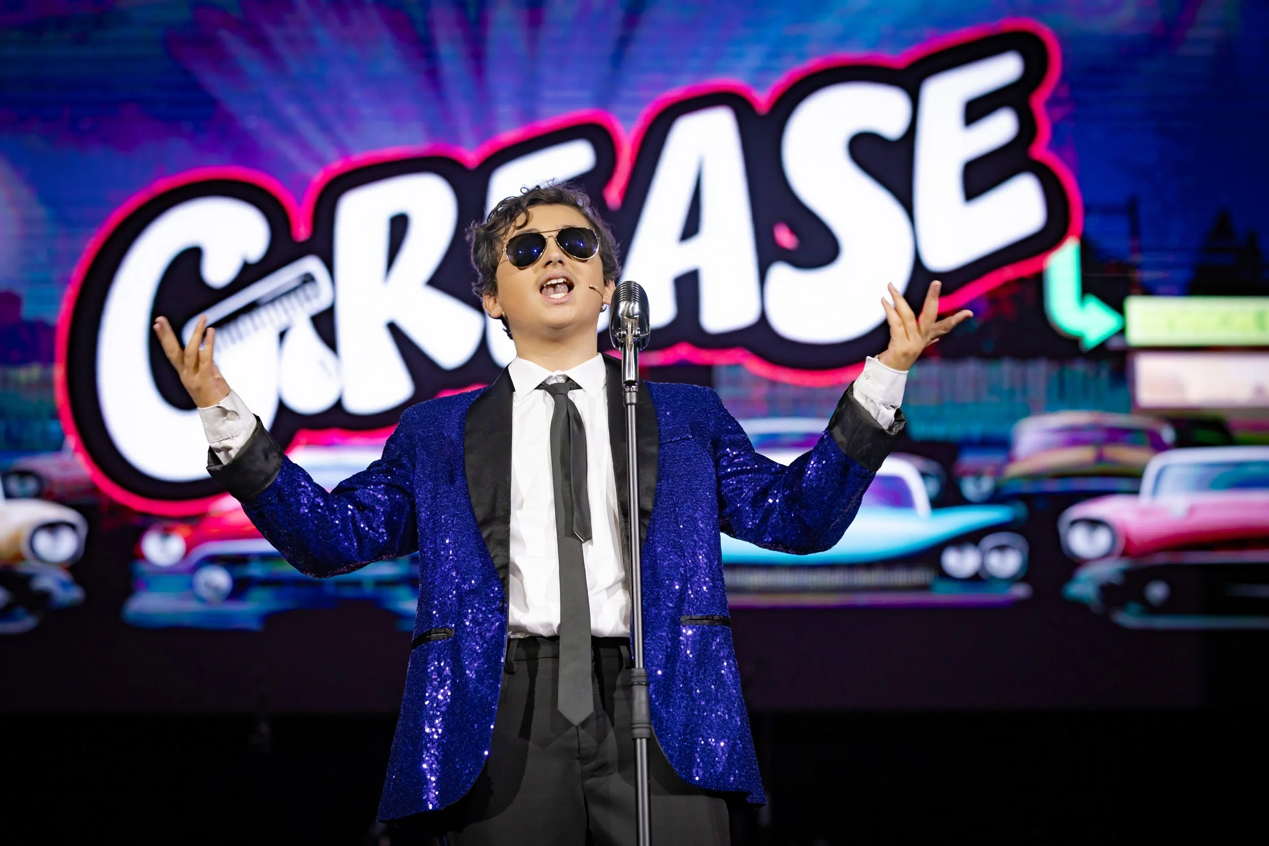 Lead performer singing during King David High School's production of Grease