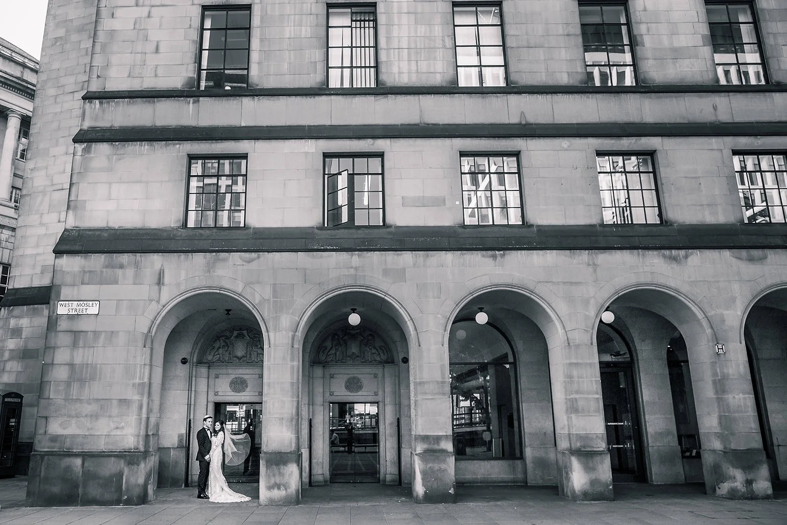bride and groom newlywed couple portrait with arches in manchester city center