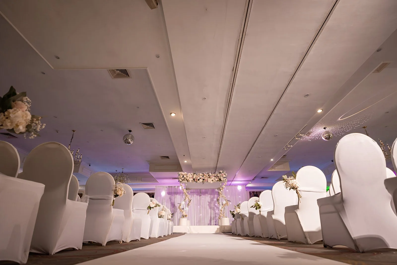 last drop village bolton wedding ceremony indoor set up with flowers