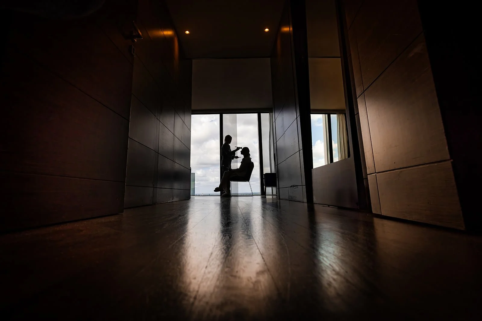 Manchester silhouette of jewish bride having make-up applied during bridal prep as captured by a wedding photographer
