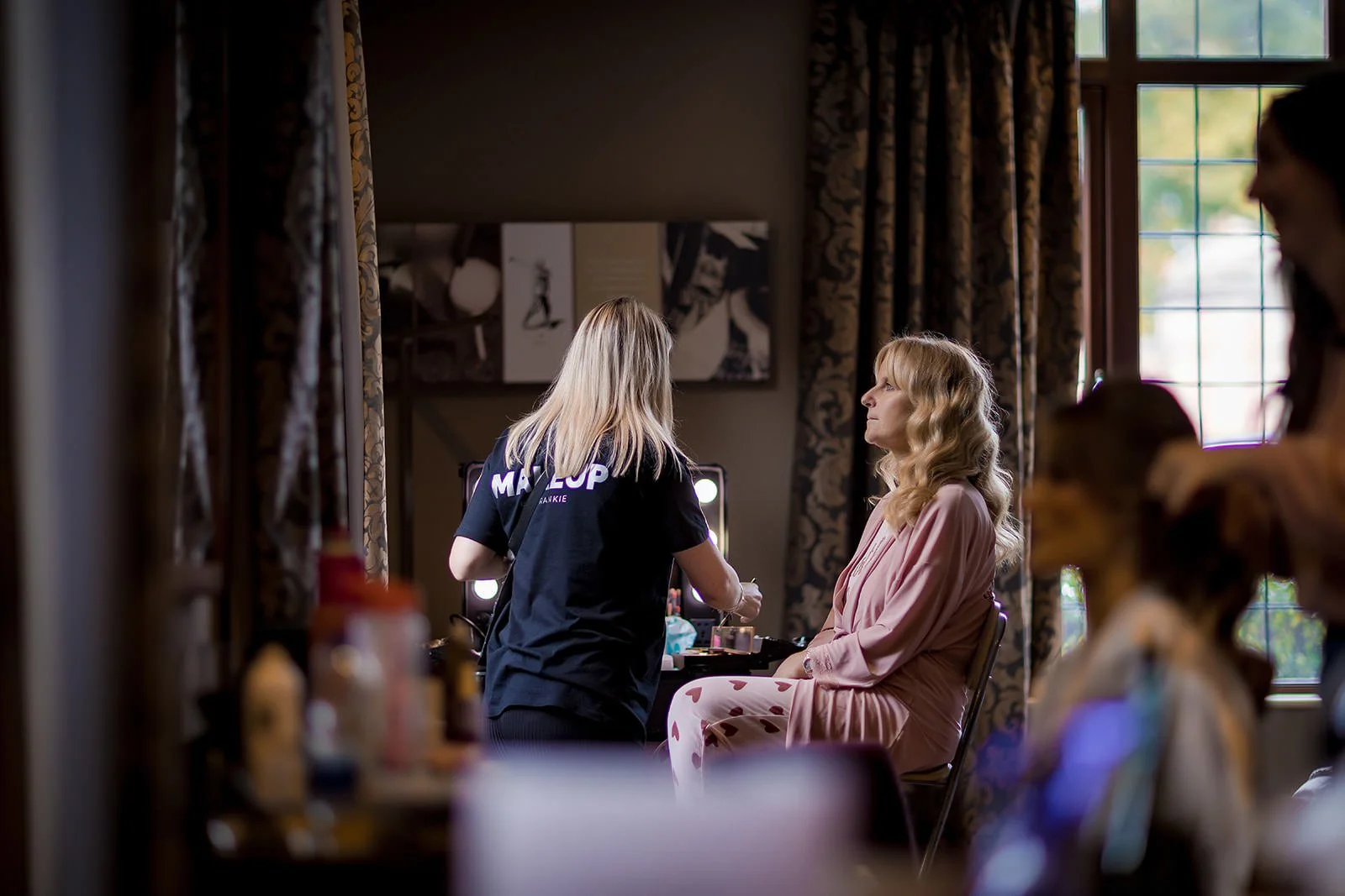 mother of bride having make up applied during prep at mere golf resort in cheshire