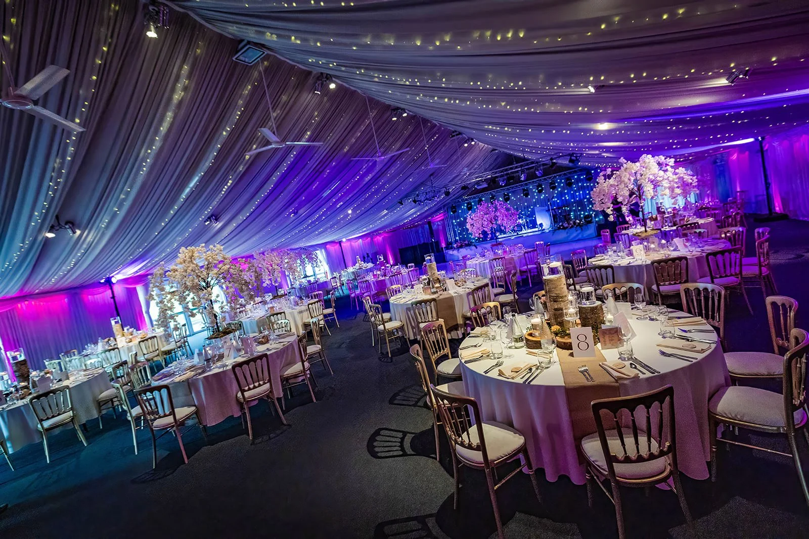 heaton house farm wedding reception dinner set up in steel barns