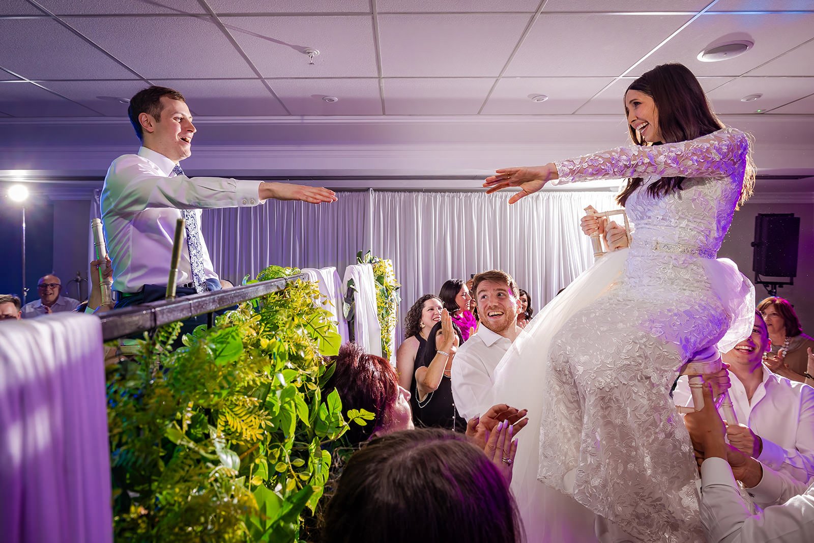 bride and groom lifted on chairs during reception party at worsley marriott hotel