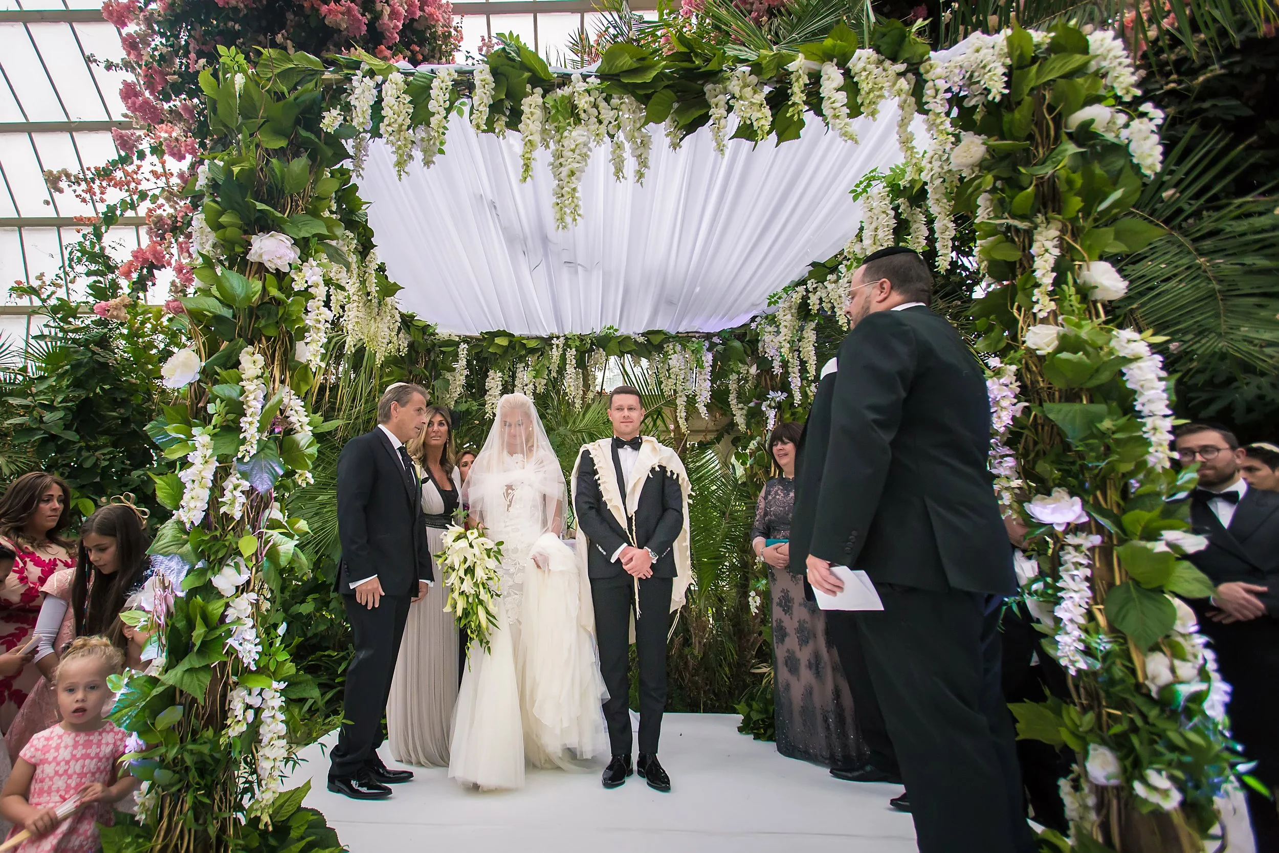 bride and groom exchange vows during ceremony at sefton park palm house wedding venue in liverpool