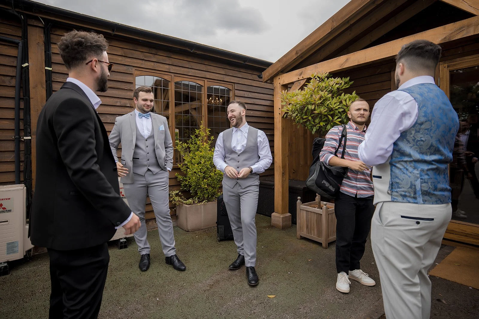 Merrydale Manor wedding groomsmen gathered outdoors before ceremony – Manchester wedding photographer