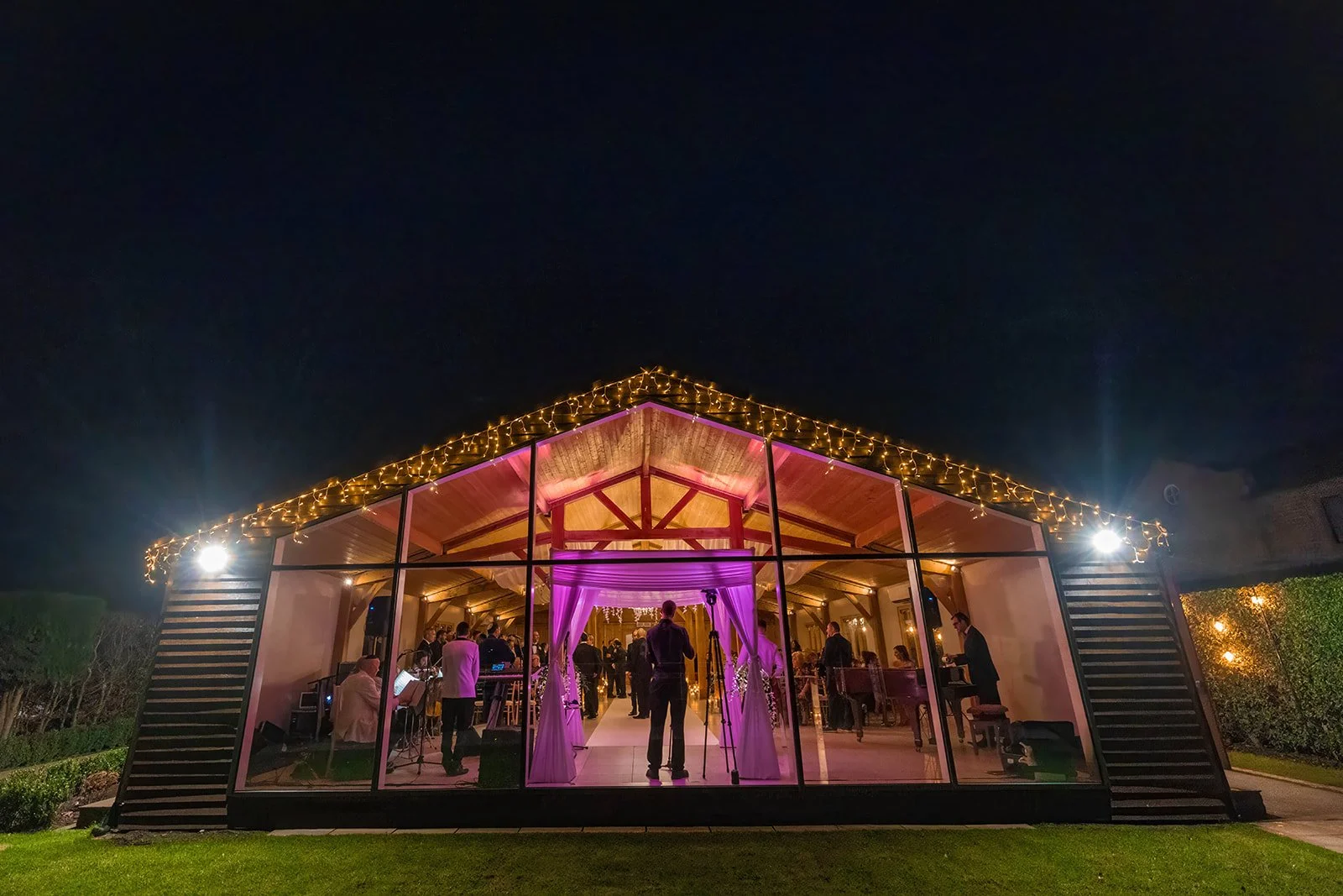 merrydale manor ceremony room exterior at night with lights