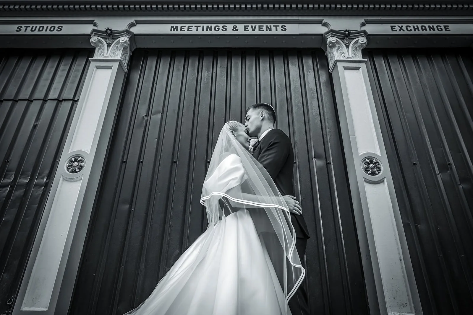 romantic newlywed bride and groom couple portrait outside manchester deansgate hotel