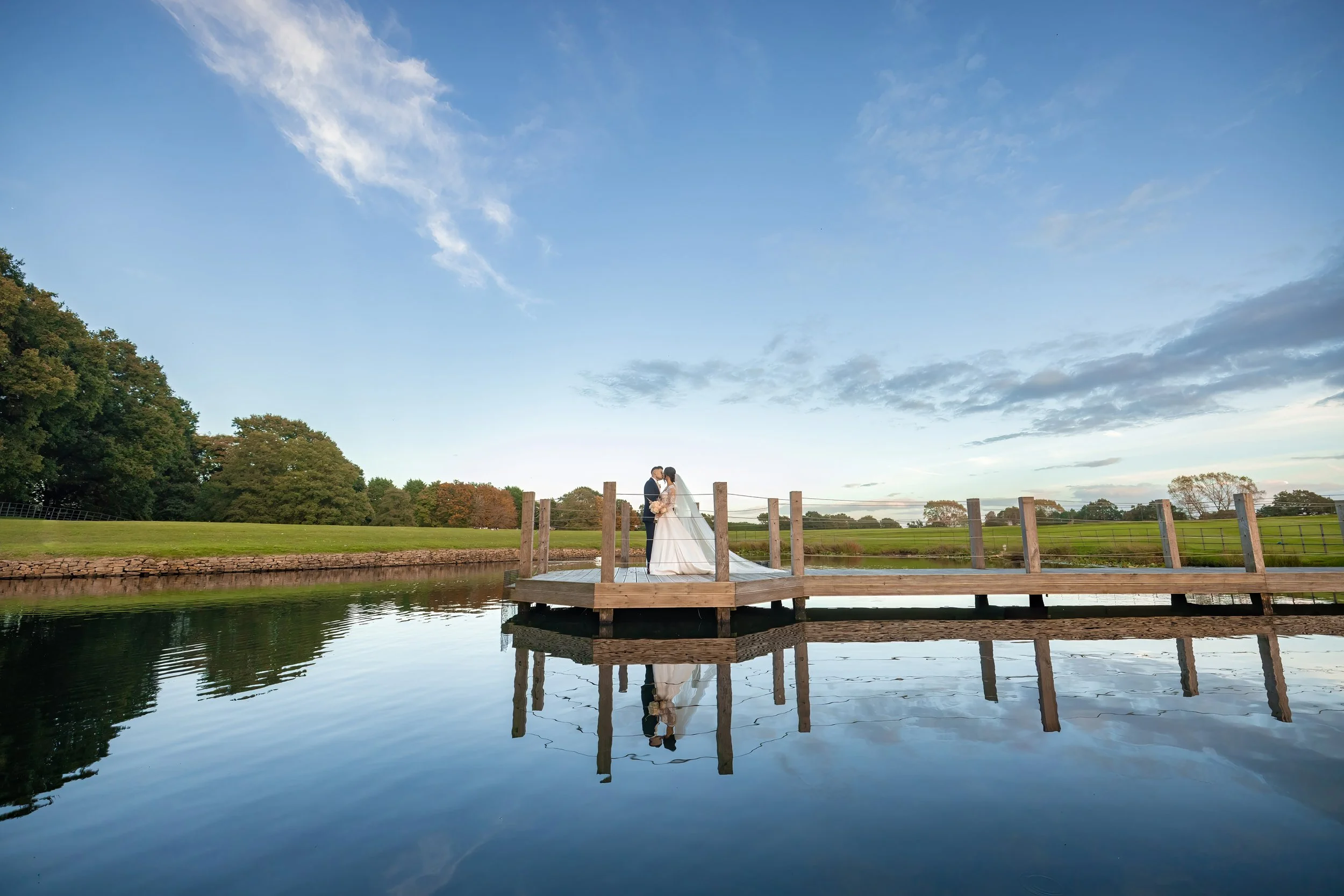 bride and groom newlywed couple portrait at merrydale manor in cheshire on the jetty over the pond